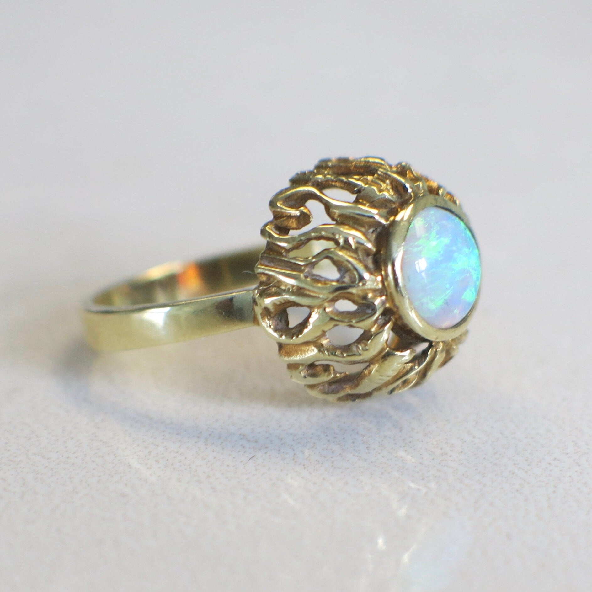 Vintage 14K yellow gold opal ring with bezel-set round cabochon, October birthstone, by Black Market LLC.