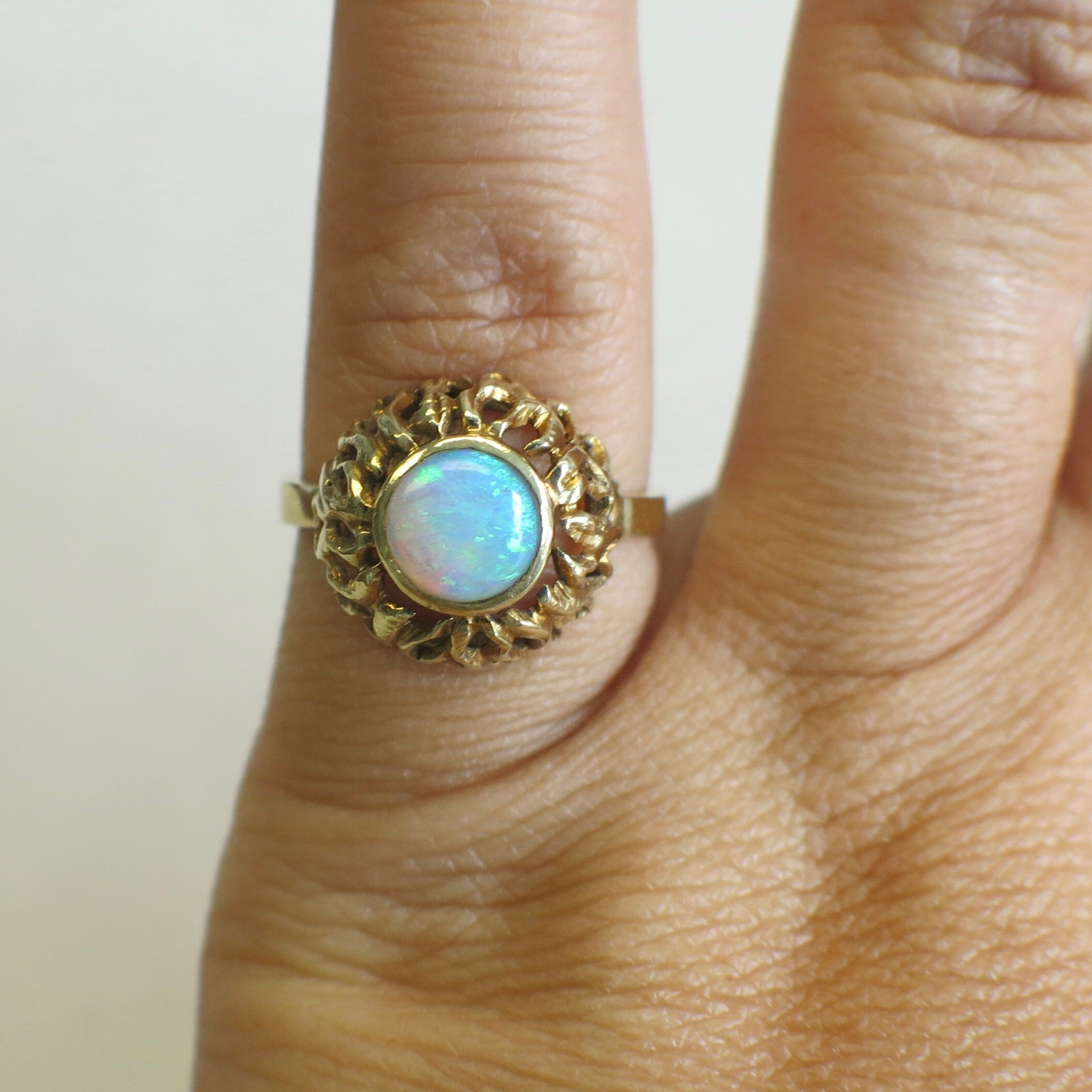 Vintage 14K yellow gold opal ring with bezel-set round cabochon, October birthstone, by Black Market LLC.