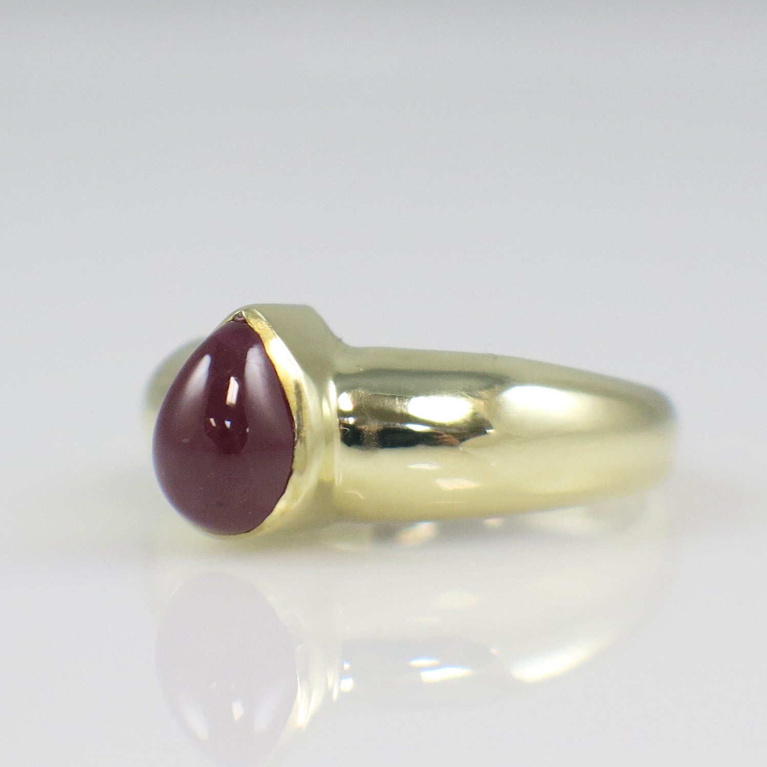 Vintage 14K yellow gold ring with pear-shaped cabochon ruby bezel setting, bold gemstone jewelry by Black Market LLC