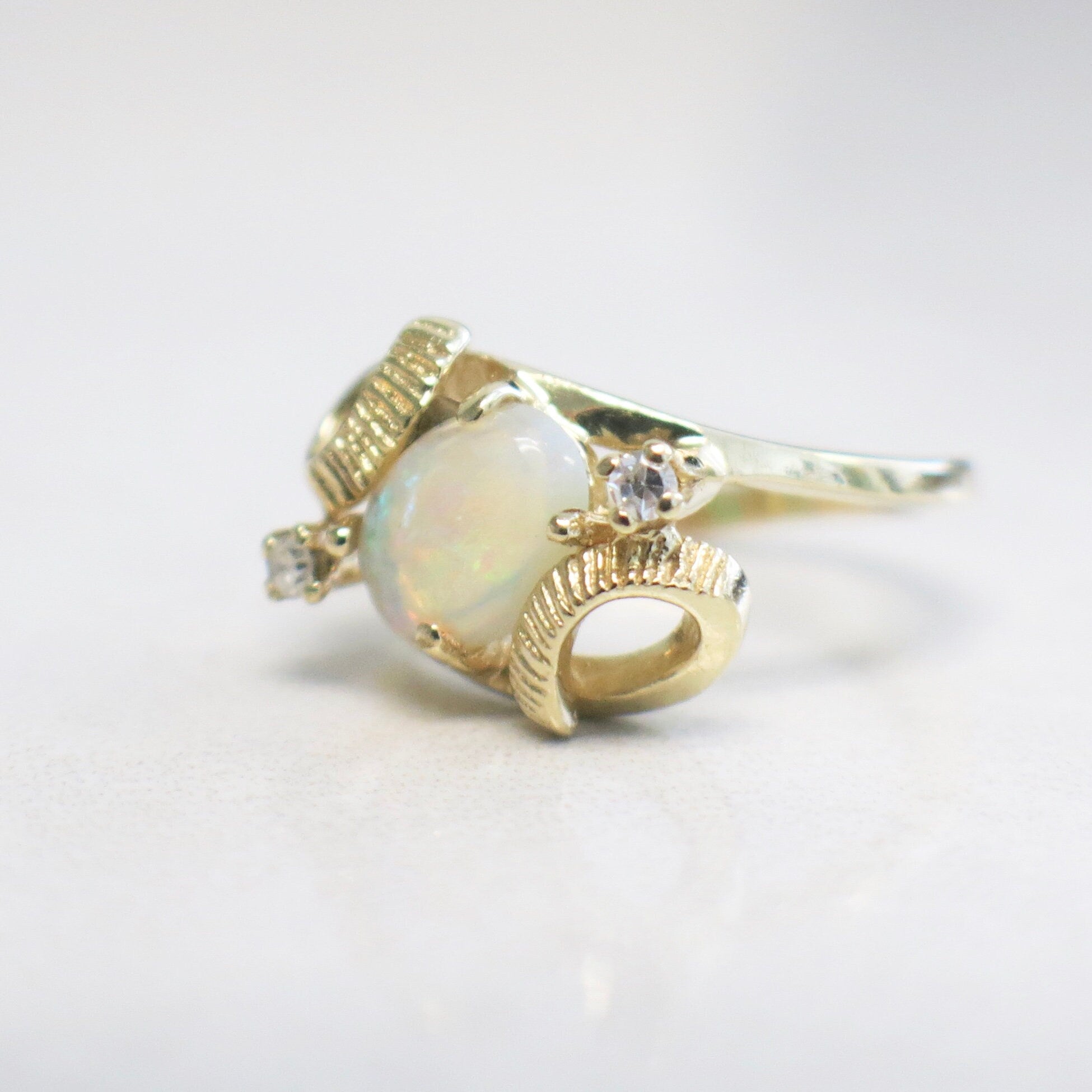 Vintage 14K yellow gold white opal and diamond ring with oval opal and European shank, size 4, by Black Market LLC.