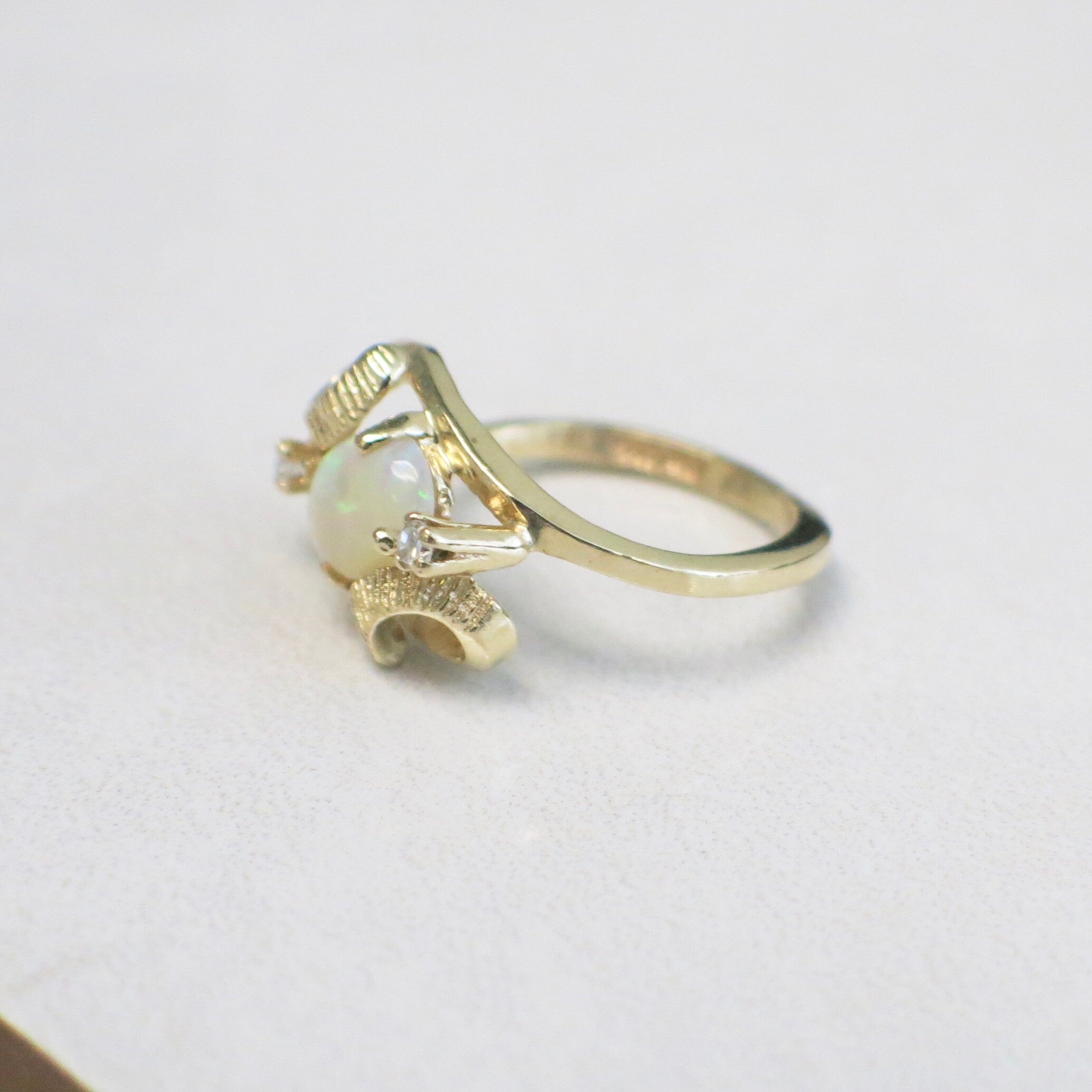 Vintage 14K yellow gold white opal and diamond ring with oval opal and European shank, size 4, by Black Market LLC.