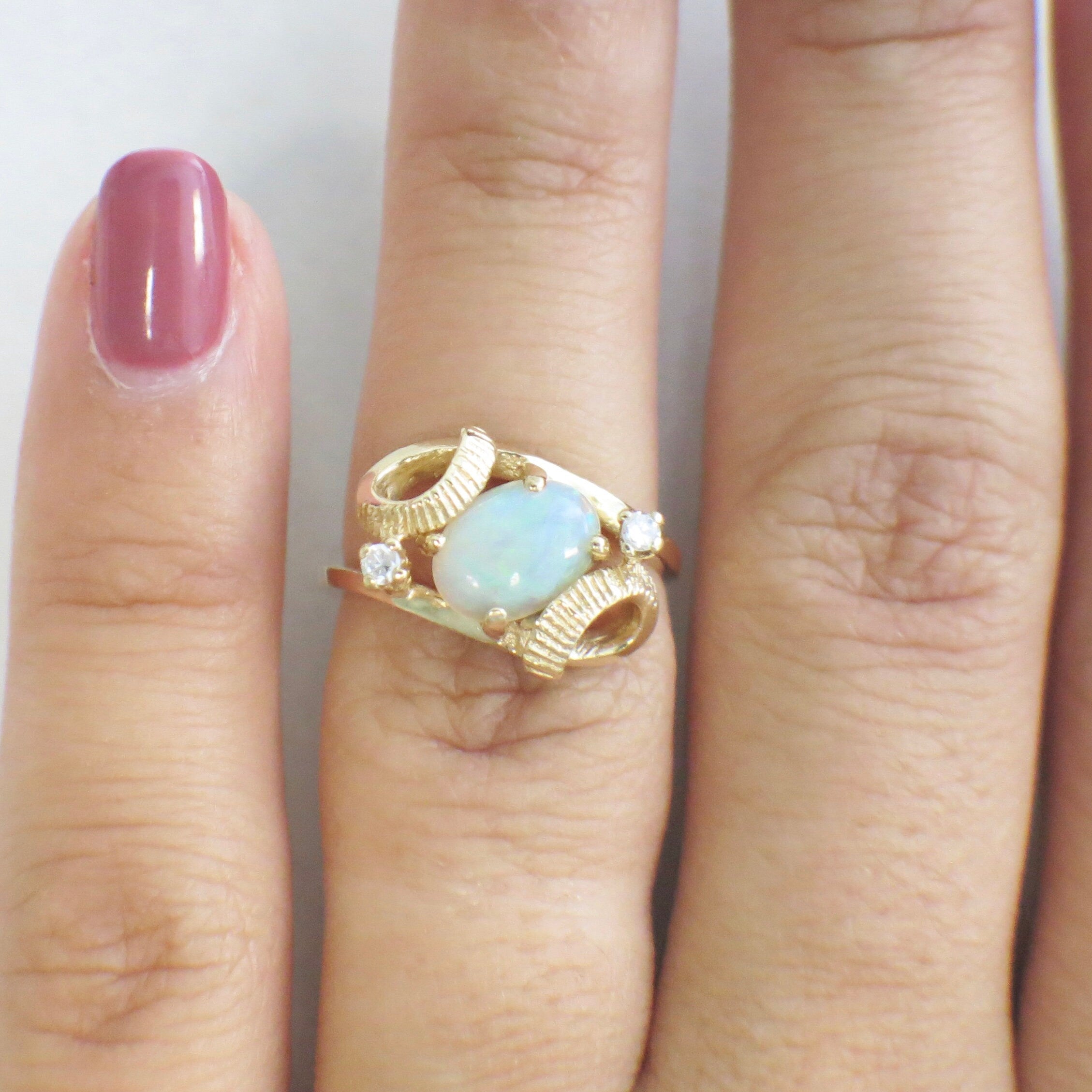 Vintage 14K yellow gold ring with oval white opal and diamond accents, featuring a European shank, size 4.