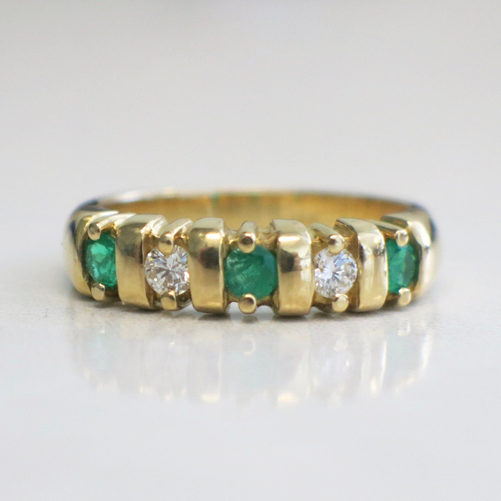 Vintage 18K yellow gold emerald and diamond five-stone anniversary ring, size 7, by Black Market LLC.