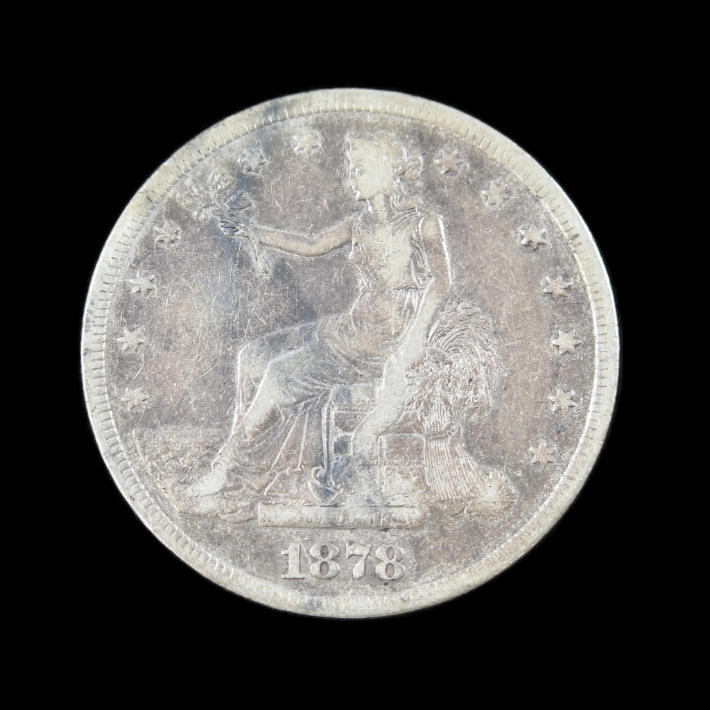 1878-S Trade Dollar US coin, raw VF grade, dark obverse toning, early U.S. silver dollar with detailed design.