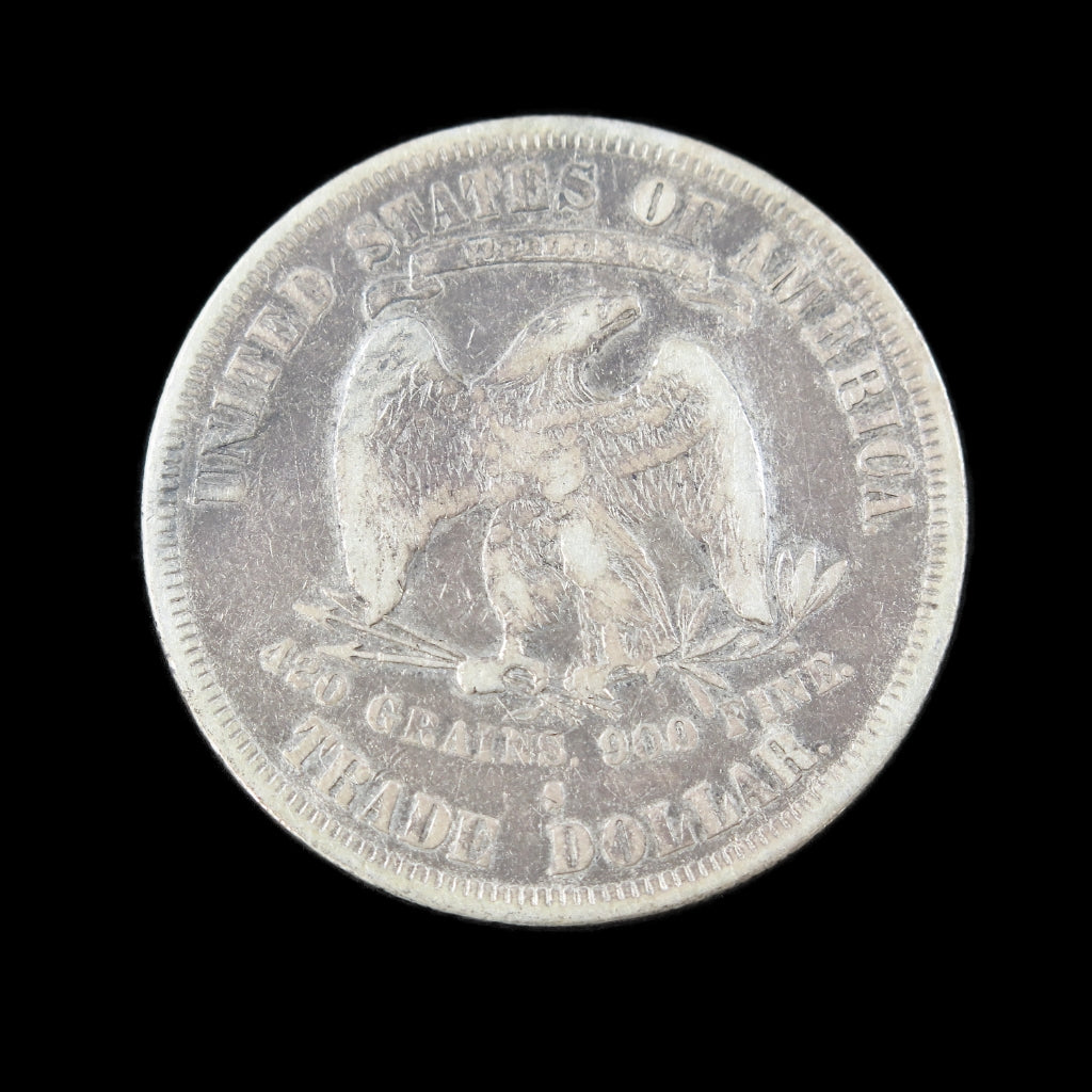 1878-S Trade Dollar US silver coin, raw VF grade with dark obverse toning and detailed design of early U.S. silver dollar.