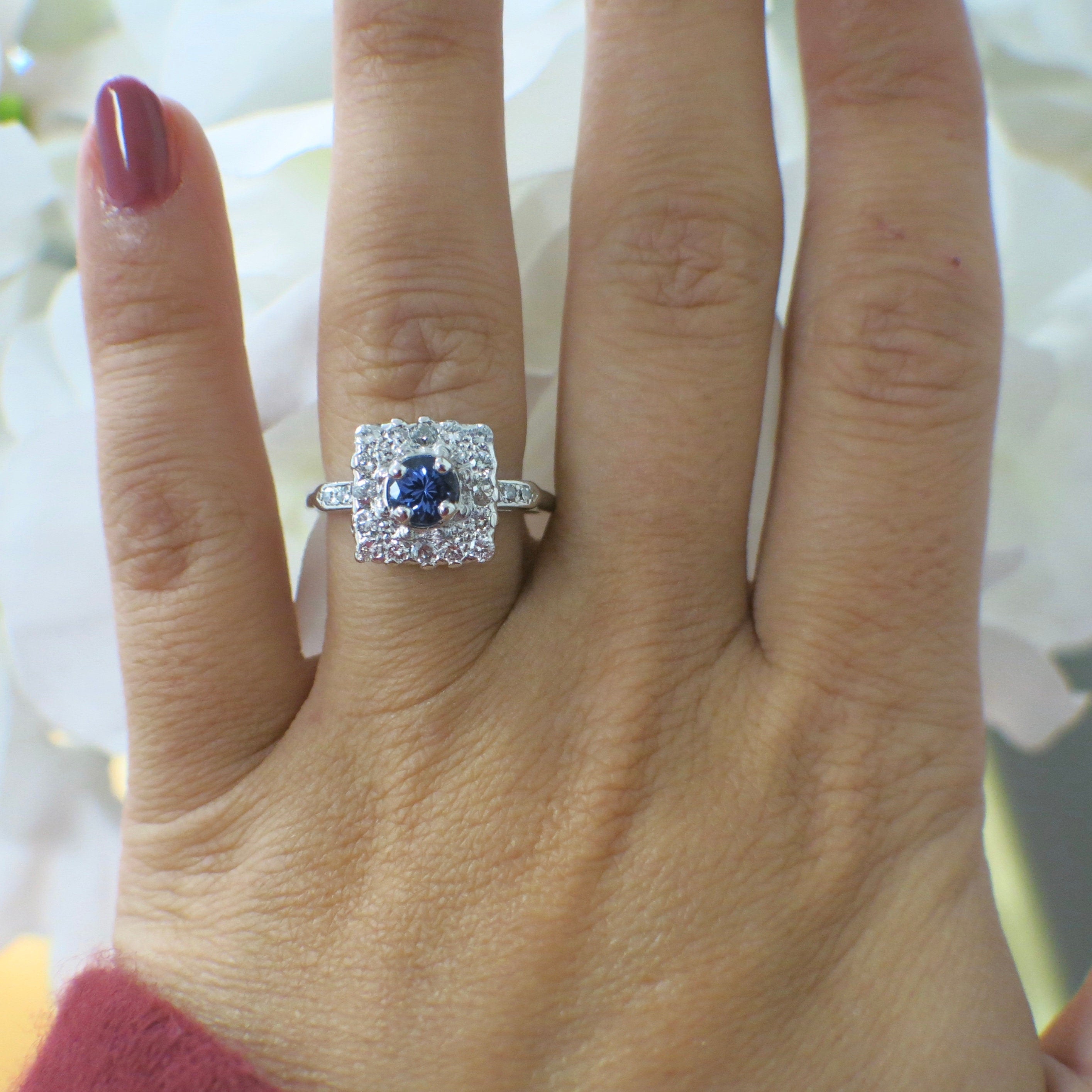 Vintage platinum tanzanite and diamond halo ring with square cluster design, 0.56 CTW diamonds, size 6.75, from Black Market LLC.