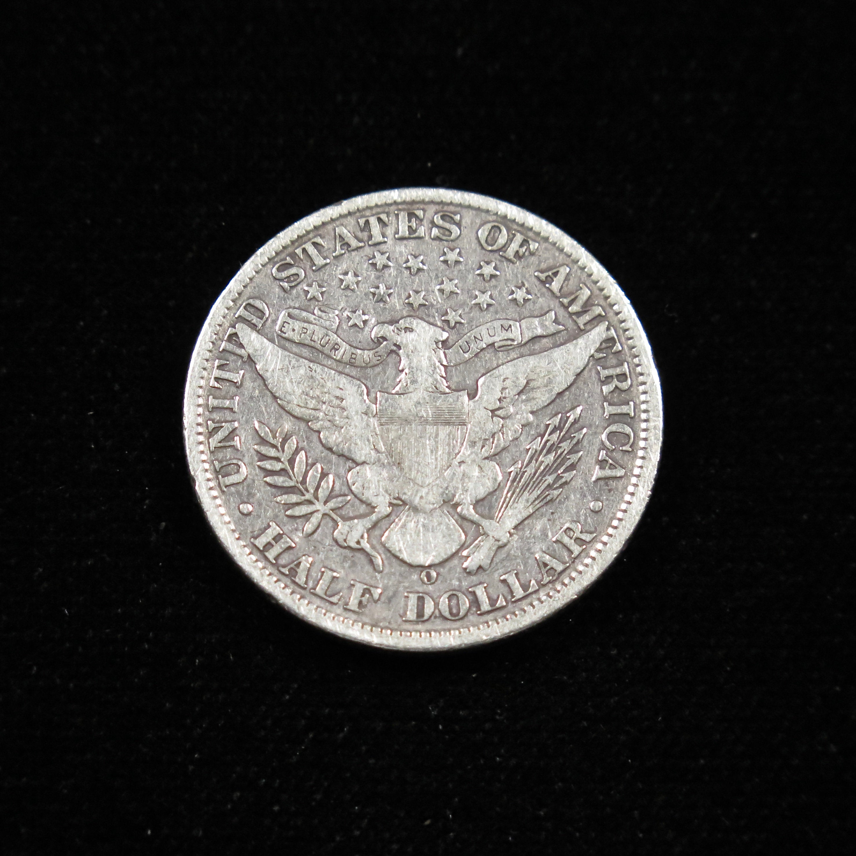 1908-O Barber Half Dollar coin in fine condition, raw, from New Orleans Mint, featuring classic U.S. silver coin design