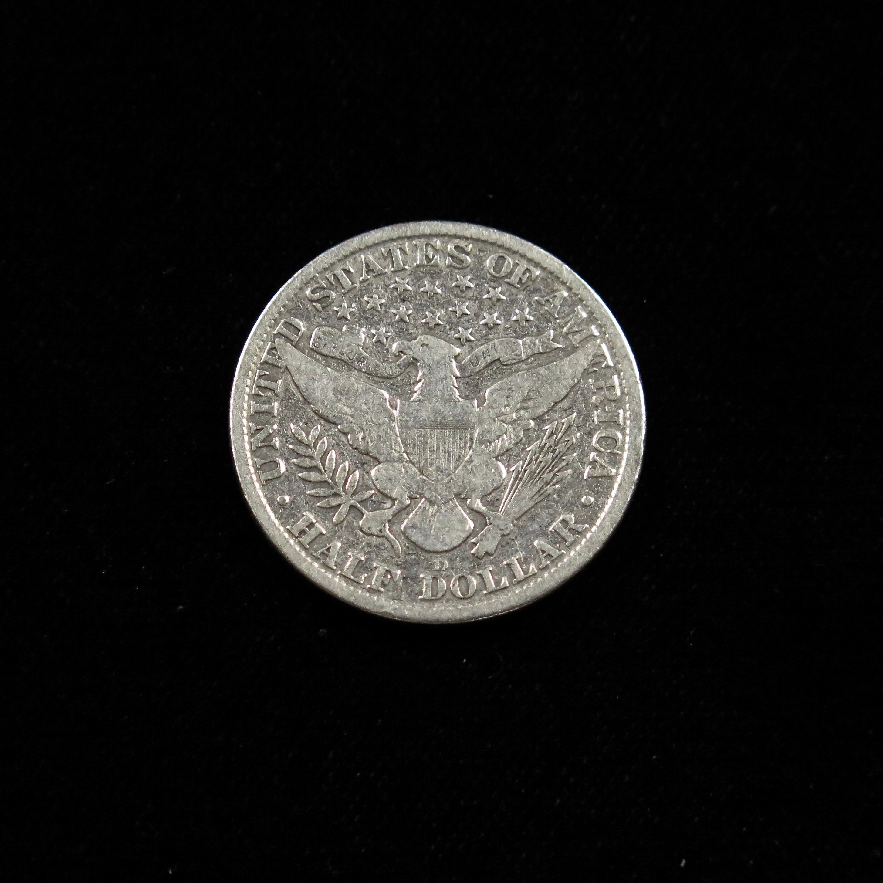 1915-D Barber Half Dollar coin from Black Market LLC, VG grade, U.S. silver coin, final year Denver Mint, raw condition.