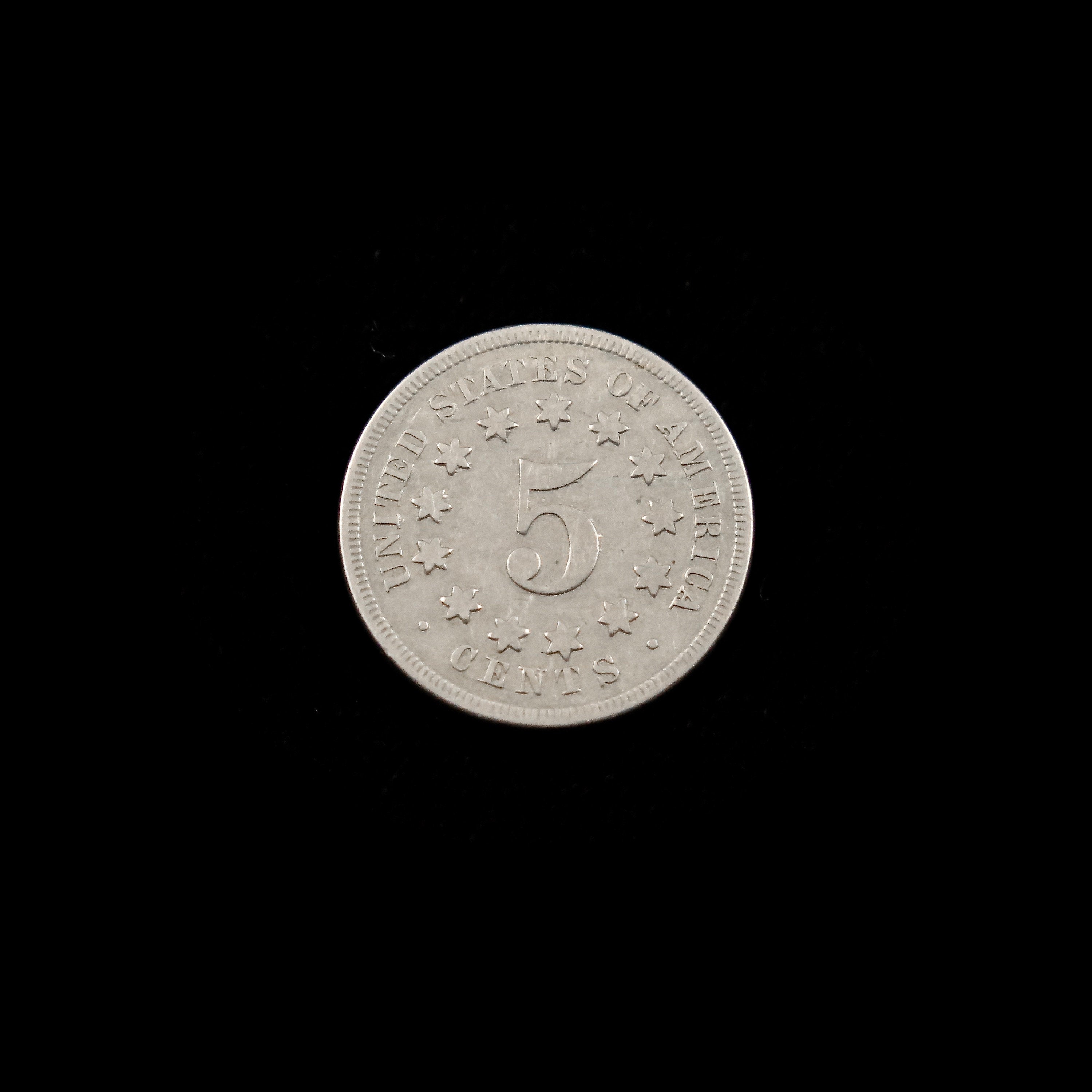 1869 Shield Nickel with narrow date, Extra Fine condition, raw U.S. five-cent coin, showcasing detailed shield design.