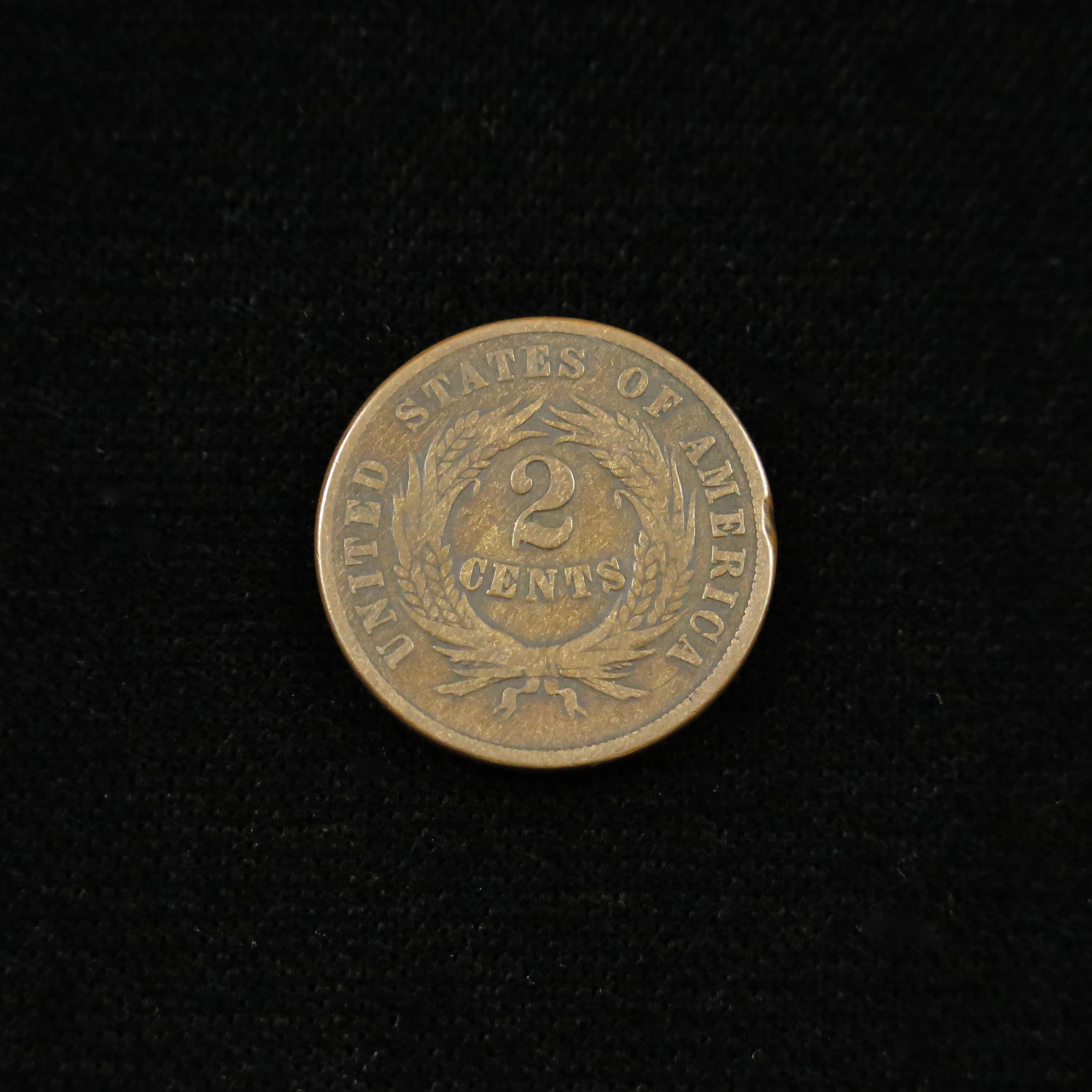 Raw 1869 Two Cent Piece by Black Market LLC, historic U.S. copper coin, scarce late-date type, detailed close-up image