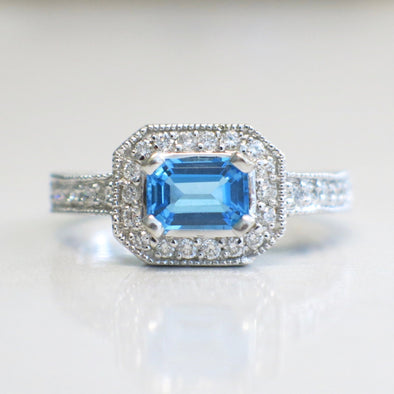 14K White Gold Emerald Cut Swiss Blue Topaz and Diamond Ring | East-West Halo