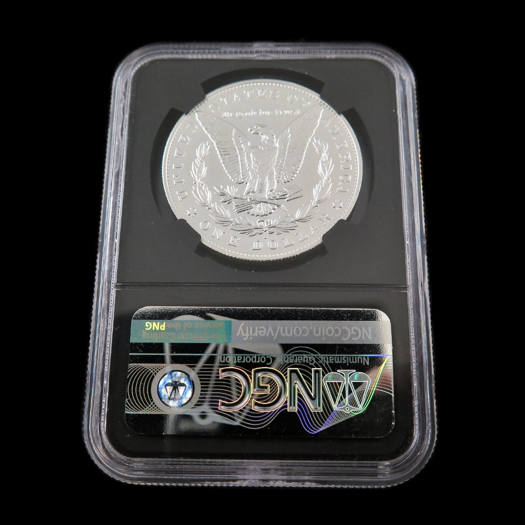 2021-S Morgan Silver Dollar commemorative coin in MS70 grade, advanced signed by Black Market LLC, displayed on a reflective surface.