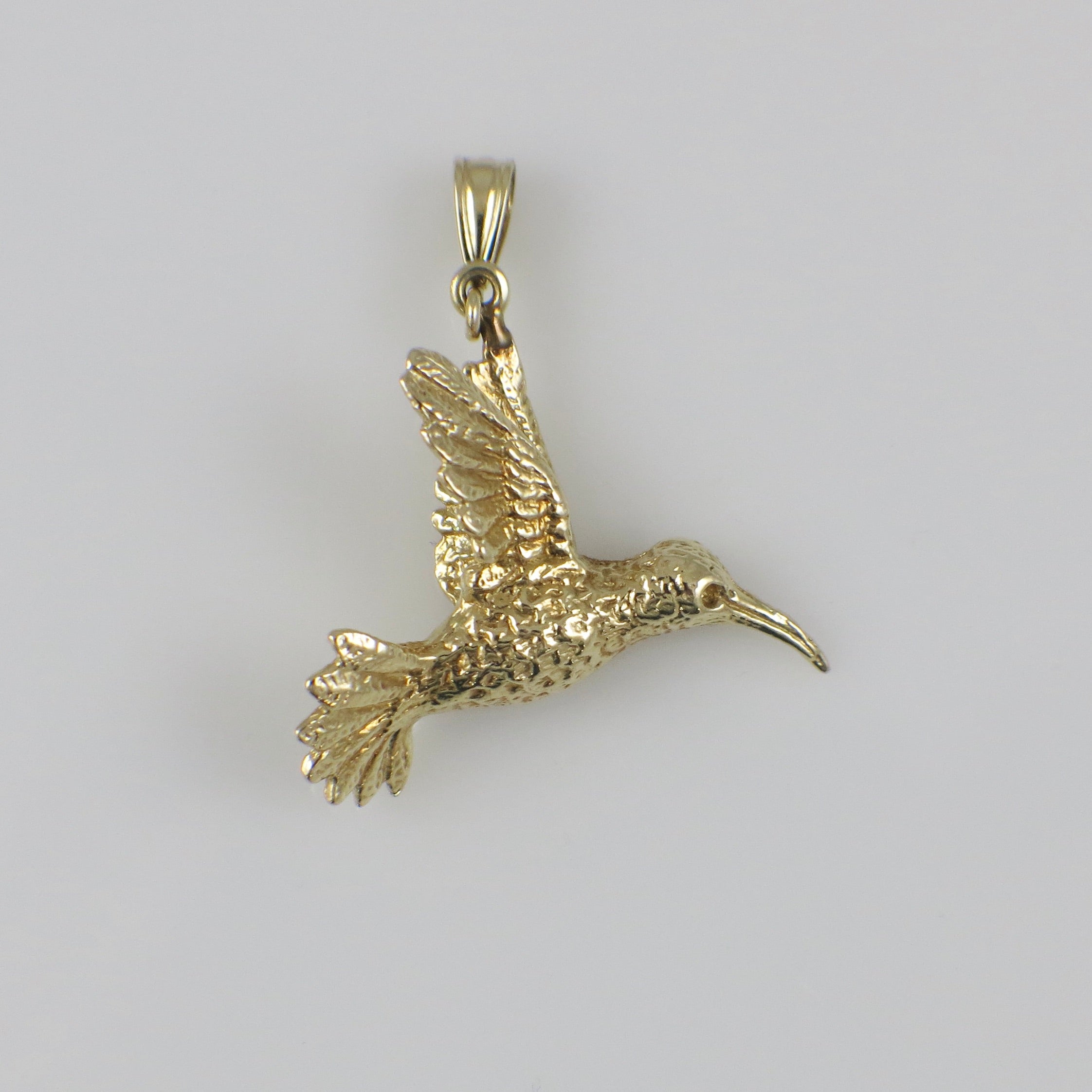 14K yellow gold hummingbird charm pendant featuring detailed bird design, crafted by Black Market LLC.