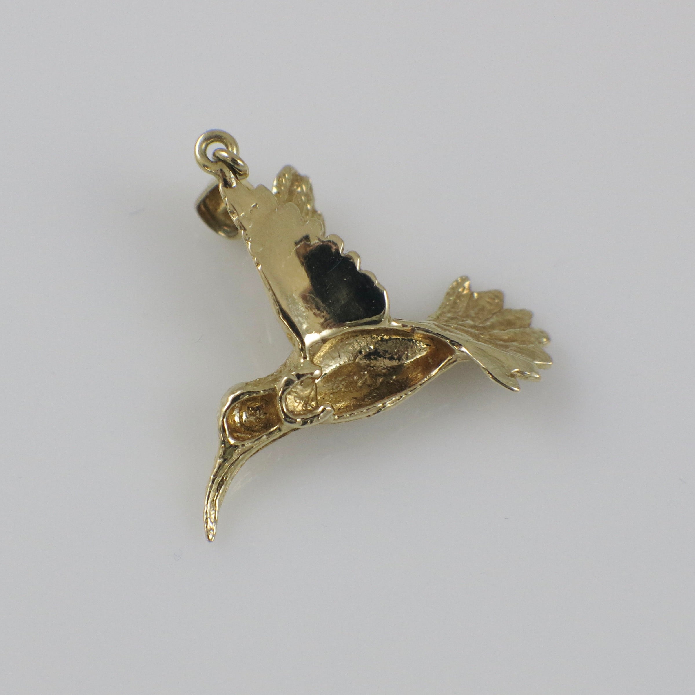 14K yellow gold hummingbird charm pendant with detailed bird design, crafted by Black Market LLC.
