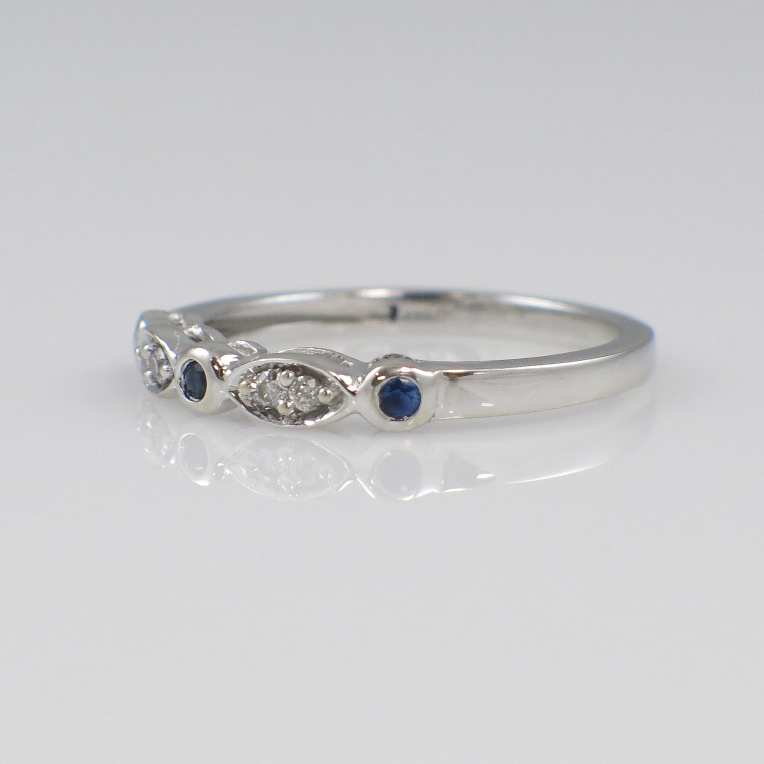 Vintage 10K white gold diamond and sapphire stackable ring with bezel setting, size 6.75, by Black Market LLC.
