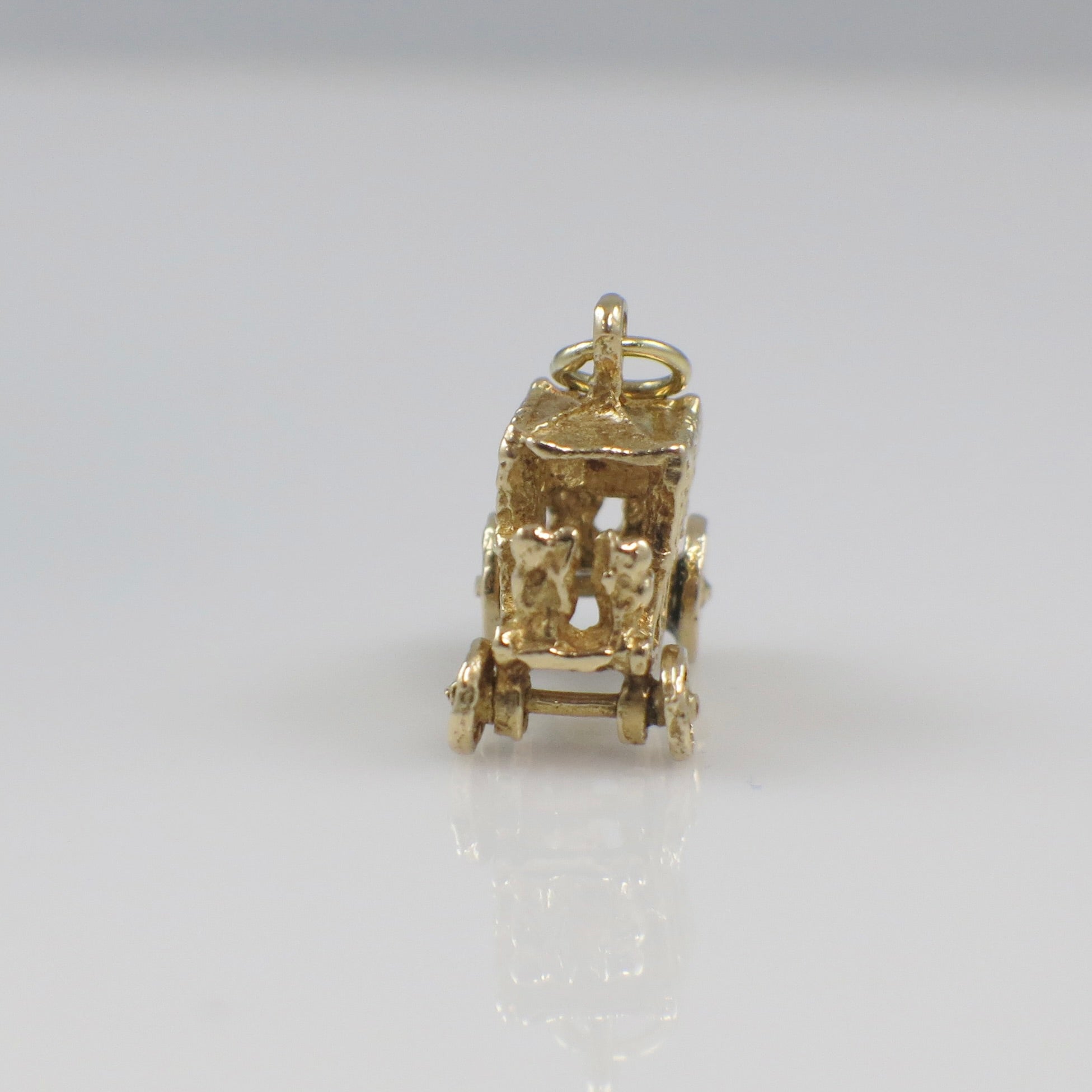 Vintage 14K yellow gold carriage charm pendant with detailed design, solid gold charm for necklaces or bracelets.