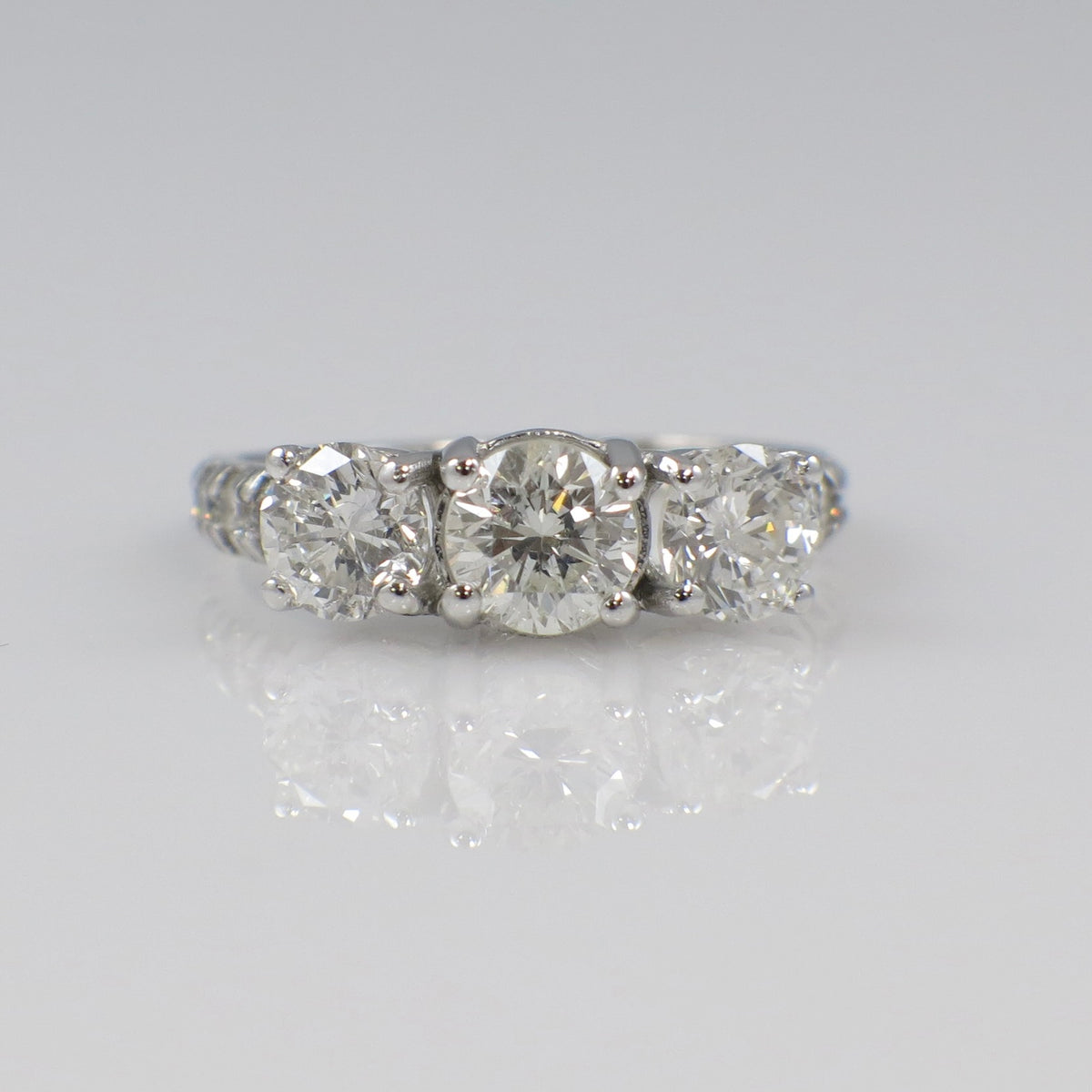 Vintage Lillian James bridal 18K white gold three-stone diamond engagement ring with 1.92 carats total weight, showcasing sparkling diamonds.