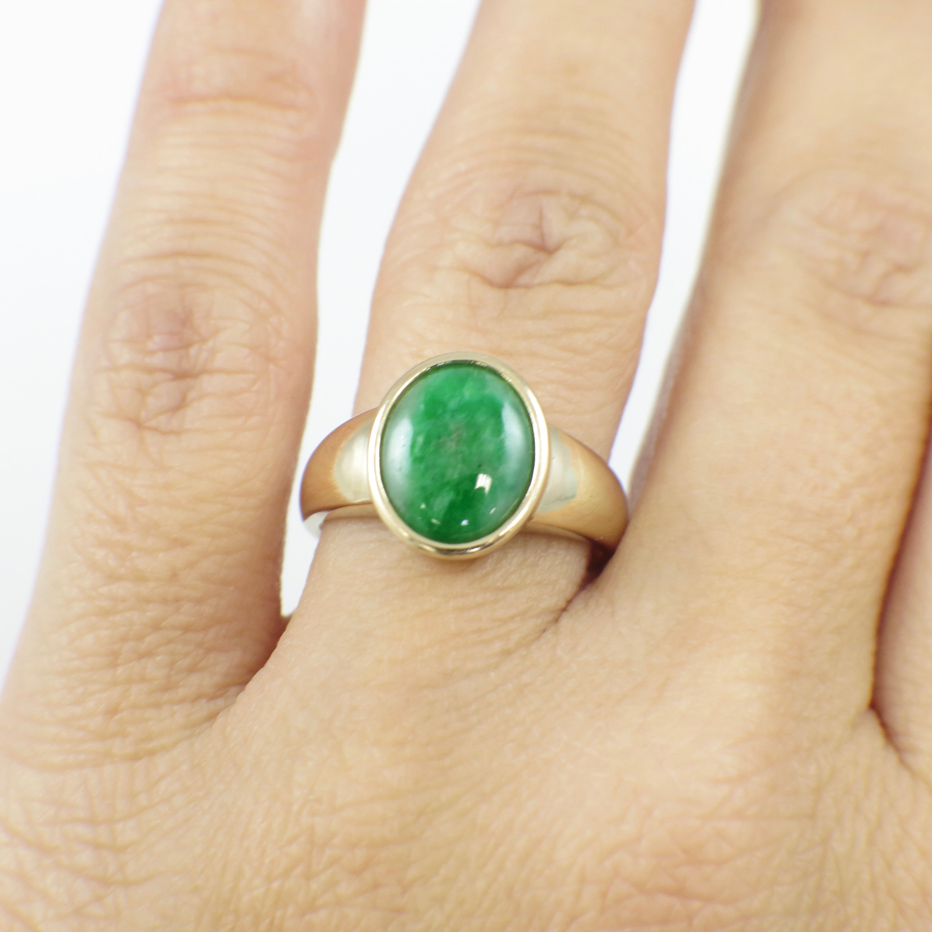 14K yellow gold jade ring with oval cabochon bezel setting, size 6.75, crafted by Black Market LLC.