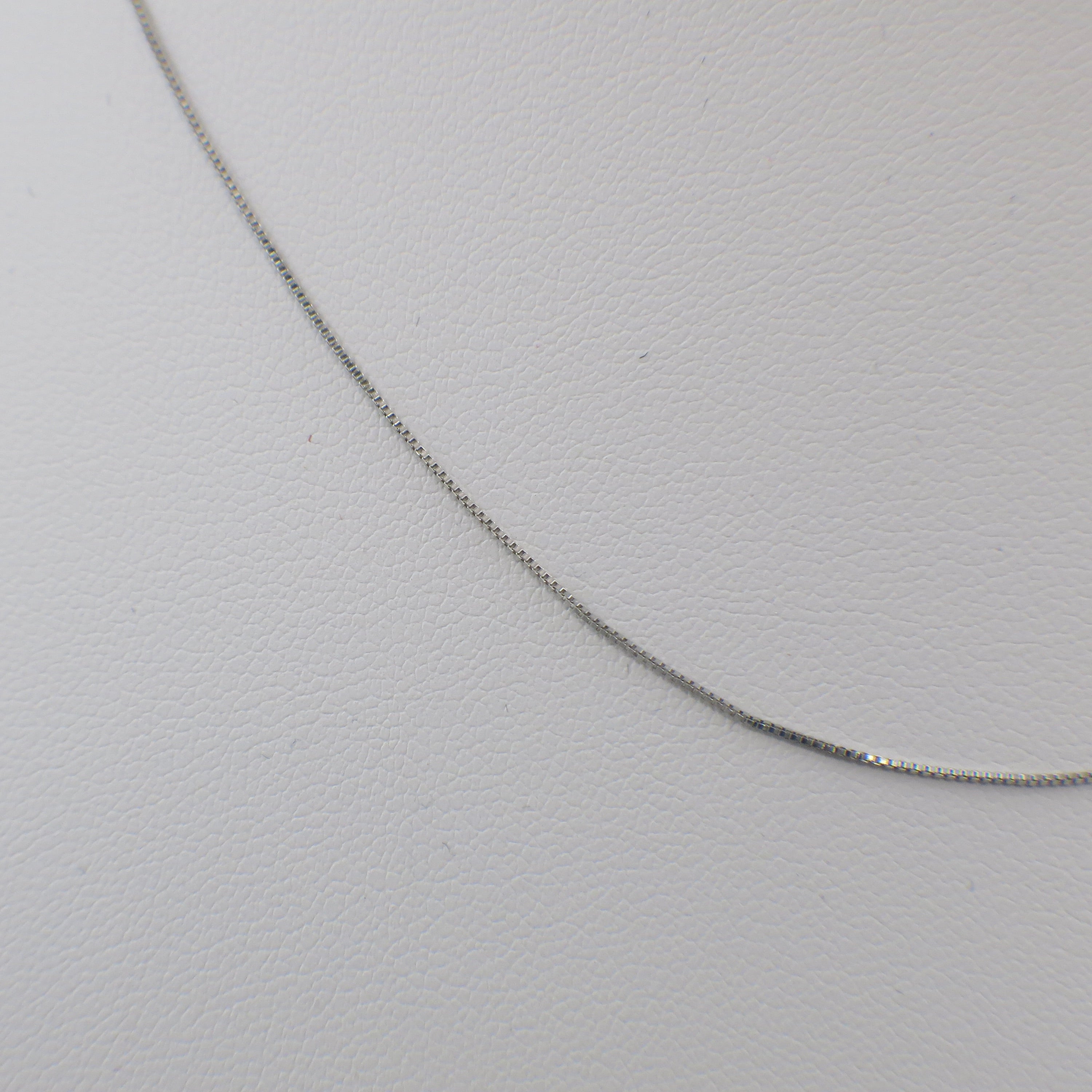 14K white gold box chain necklace, 18 inches long, 0.5mm width, from Black Market LLC, displayed on a neutral background.
