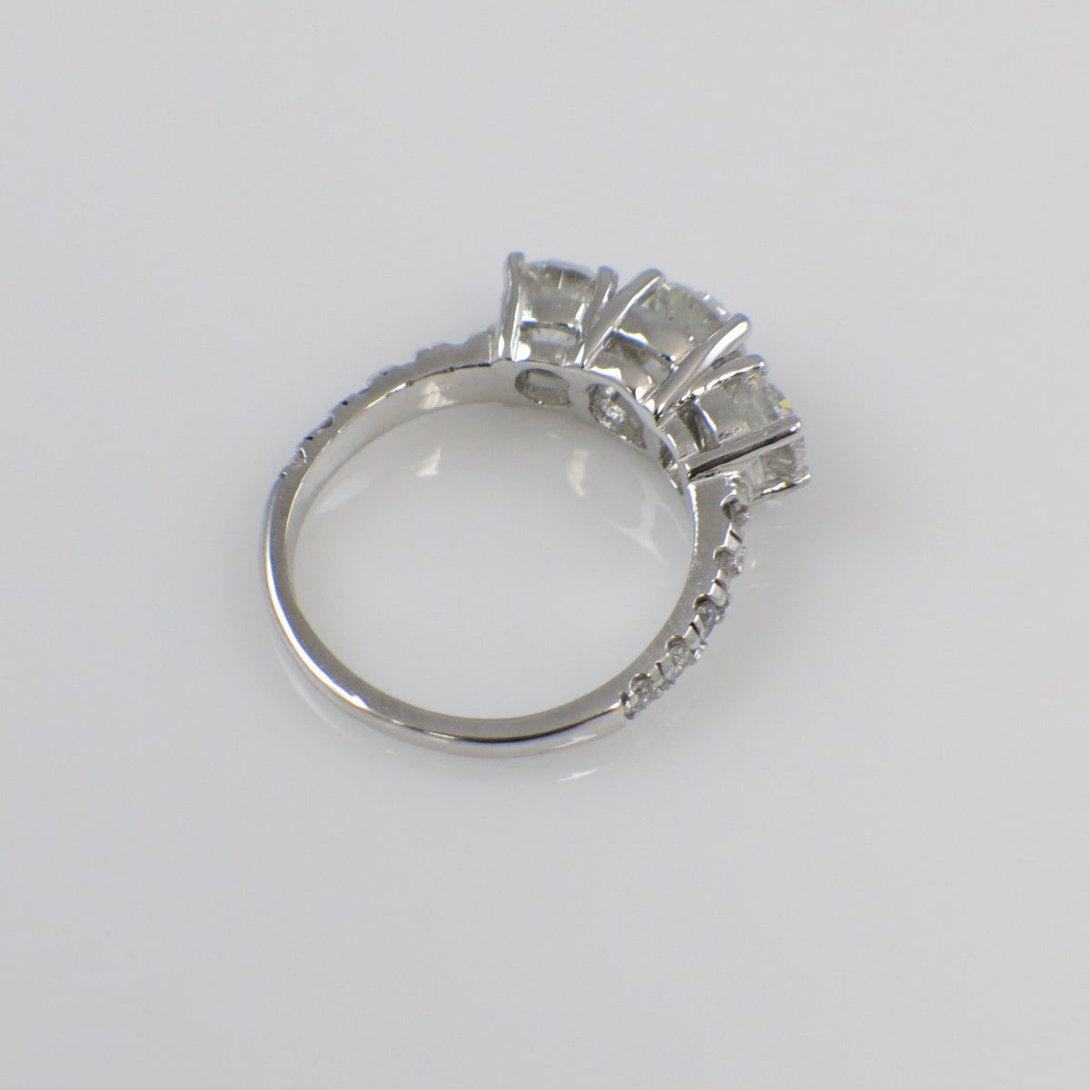 Vintage 18K white gold three-stone diamond engagement ring with 1.92 CTW from Lillian James Bridal, showcasing sparkling diamonds.