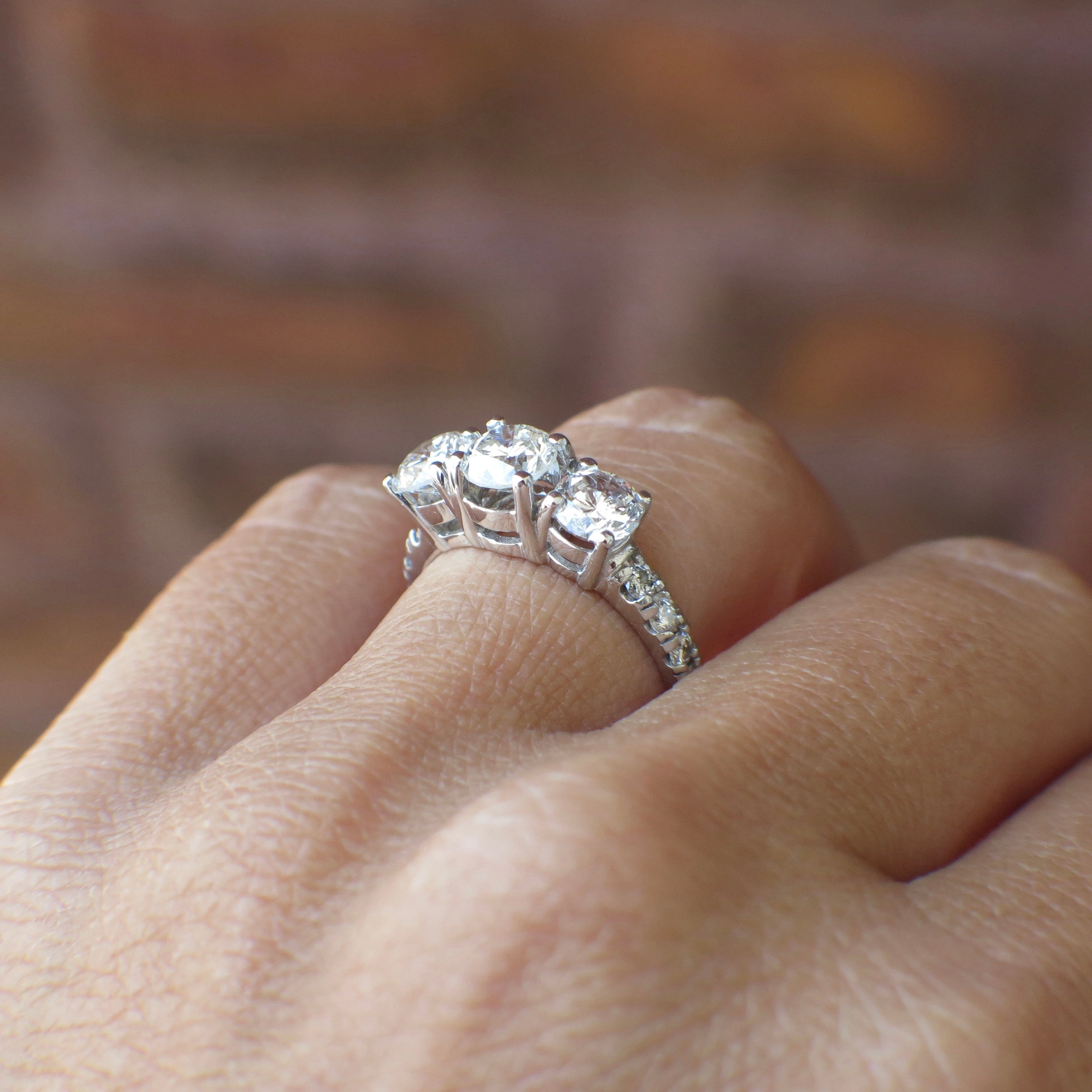 Vintage Lillian James bridal 18K white gold engagement ring featuring three diamond stones totaling 1.92 carats.