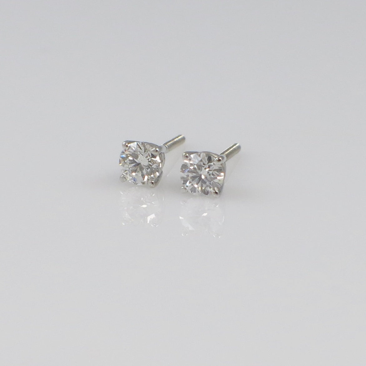 Natural diamond stud earrings with 0.30 CTW in 14K white gold, featuring threaded backs. Black Market LLC jewelry.