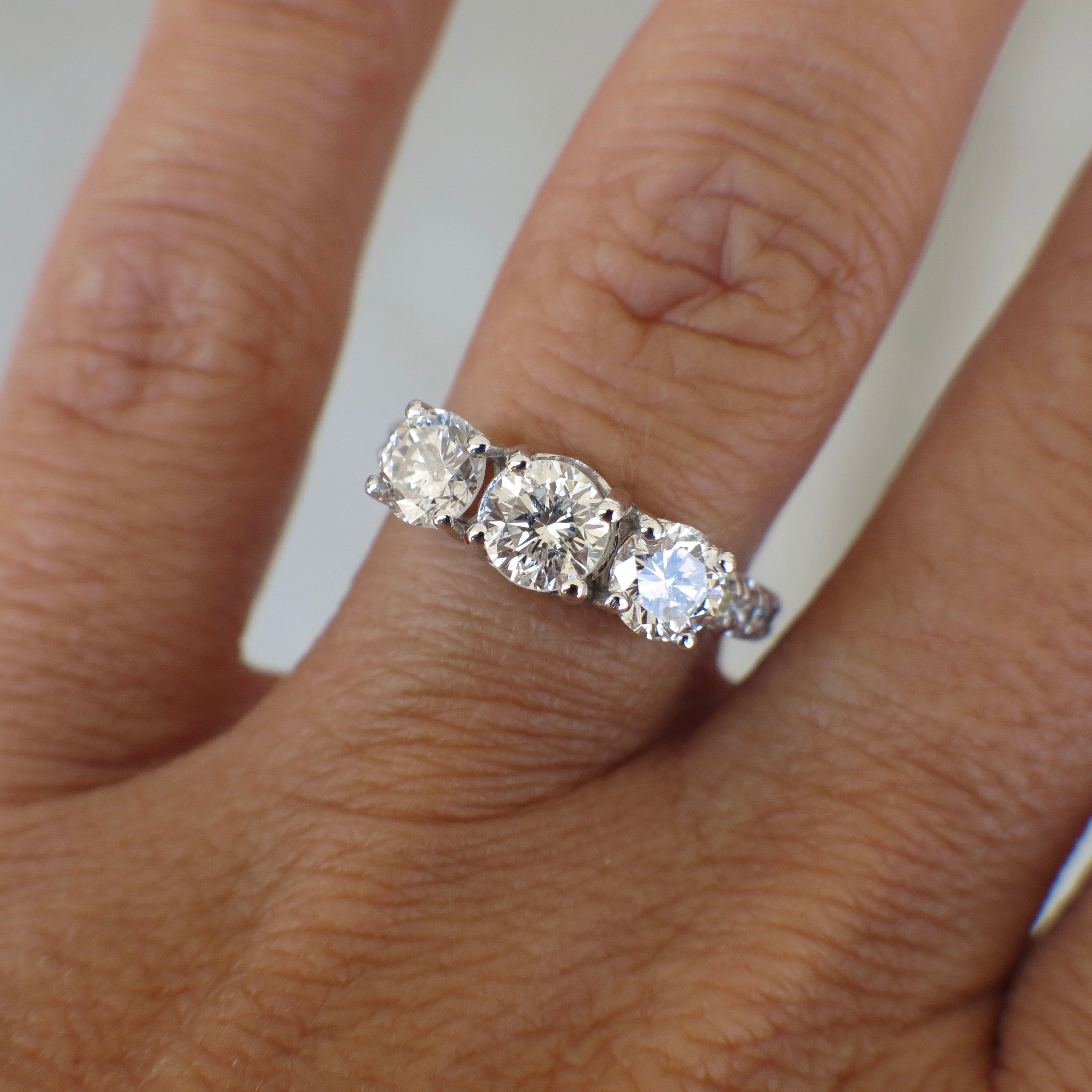Vintage Lillian James bridal 18K white gold three stone diamond engagement ring with 1.92 CTW, showcasing sparkling diamonds and elegant design.