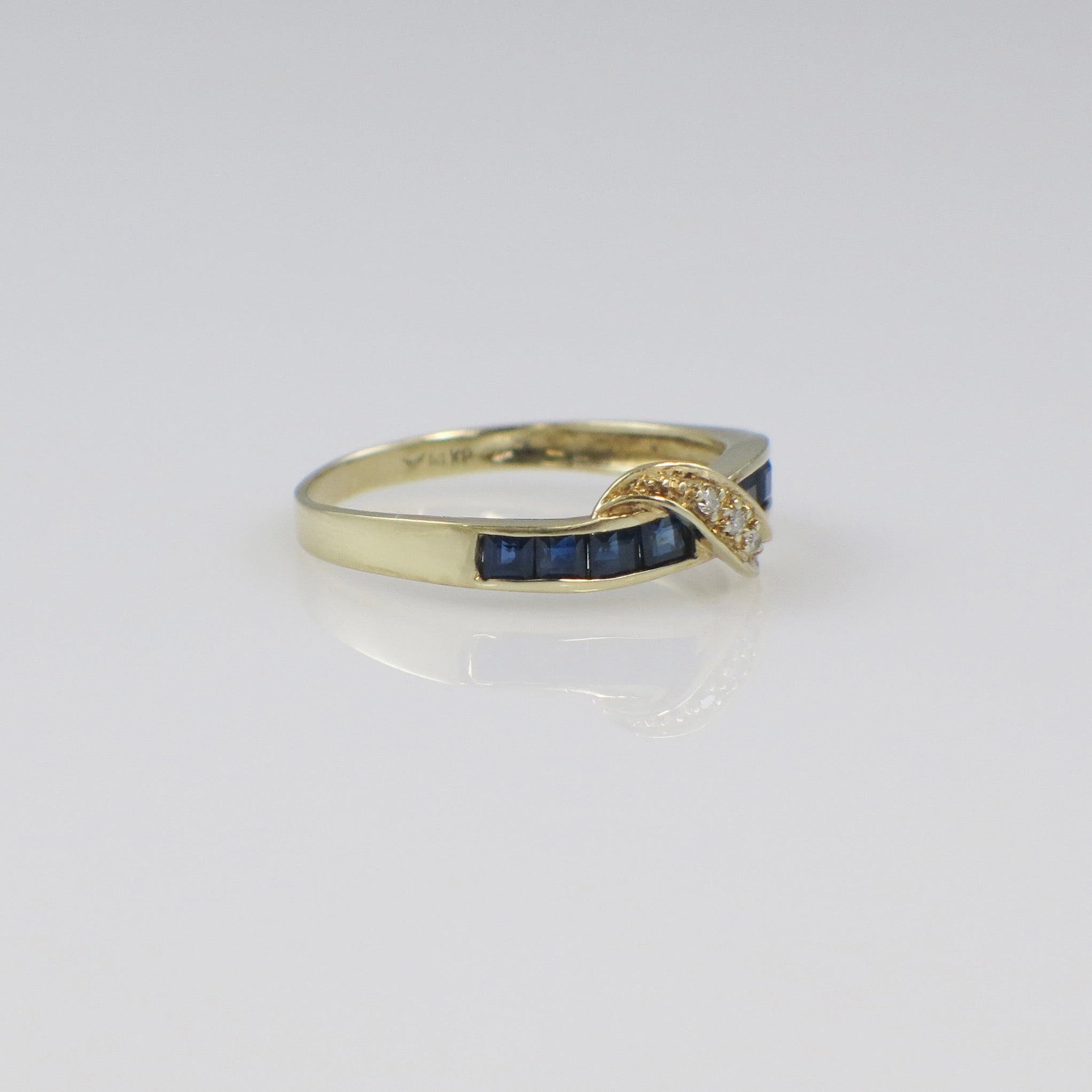 Vintage 14K yellow gold sapphire and diamond bypass ring with intricate detailing by Black Market LLC.