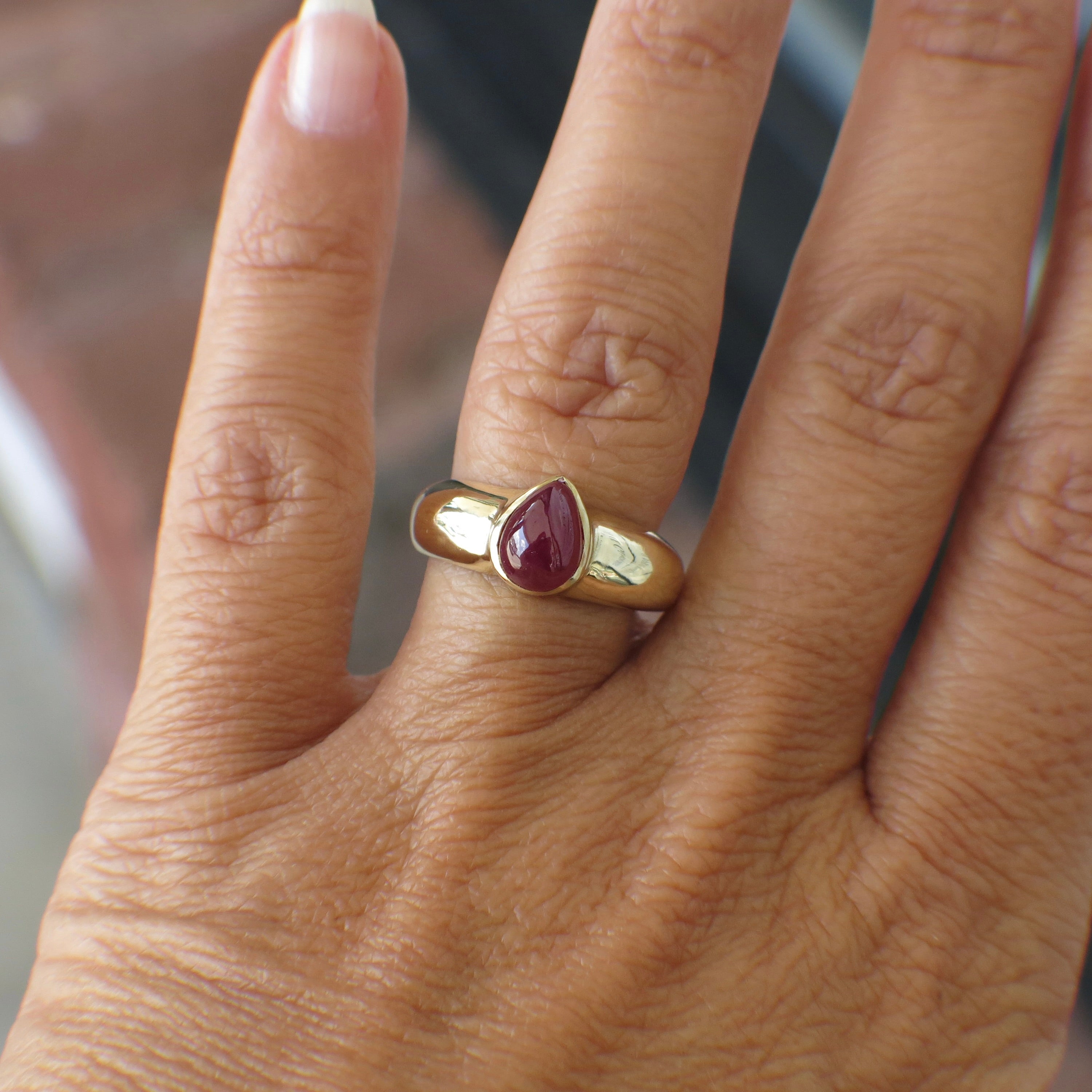 Vintage 14K yellow gold ring featuring a pear-shaped cabochon ruby bezel setting, crafted by Black Market LLC.