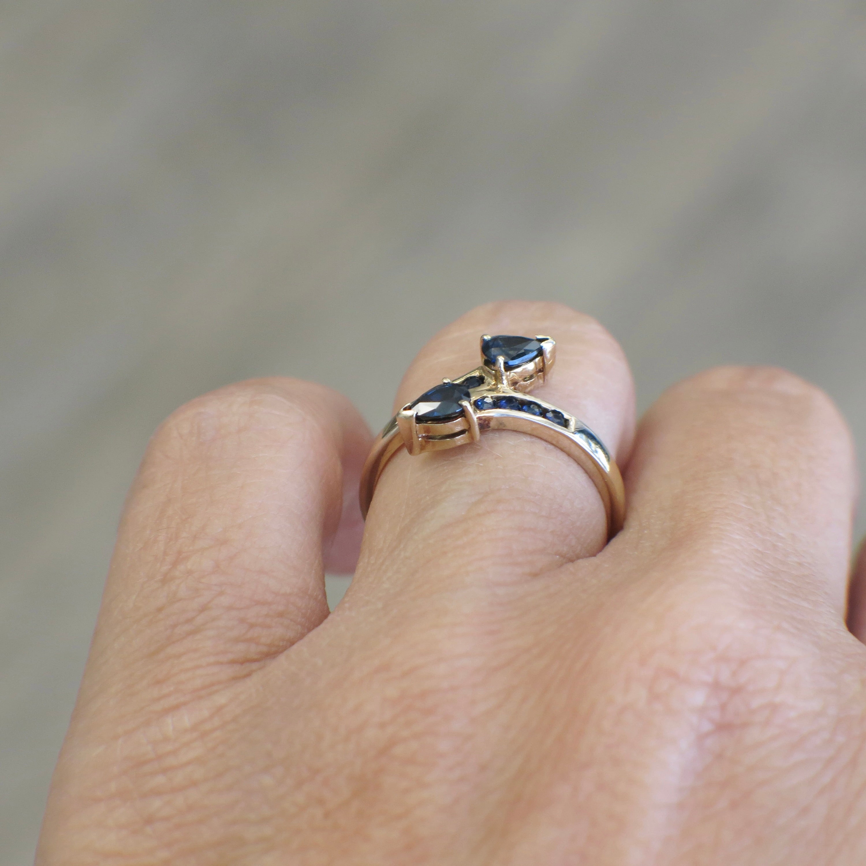 Vintage 14K yellow gold sapphire pear bypass ring featuring a prominent gemstone and sleek design.
