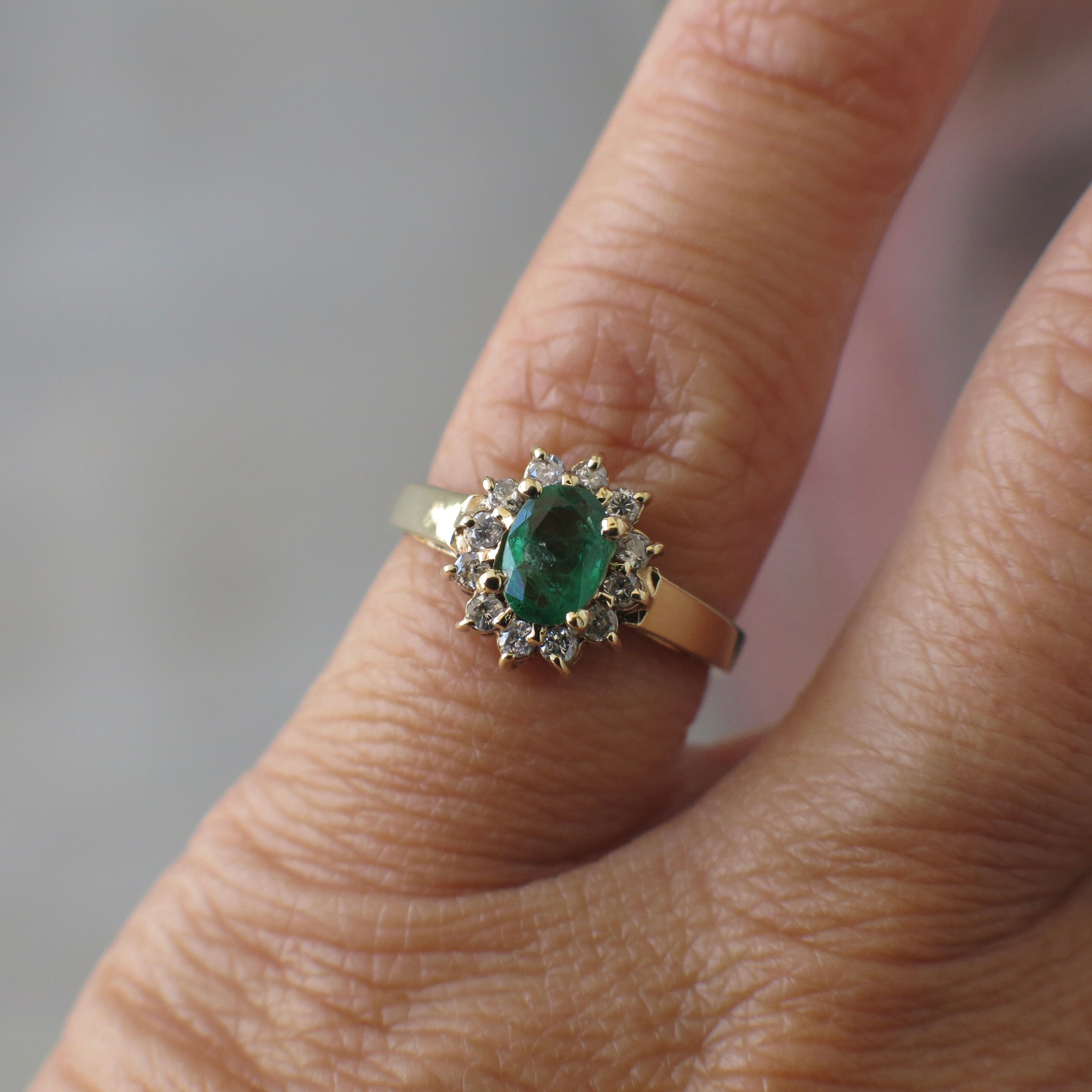 Vintage 14K yellow gold emerald diamond halo ring with intricate design and sparkling gemstones, crafted by Black Market LLC.