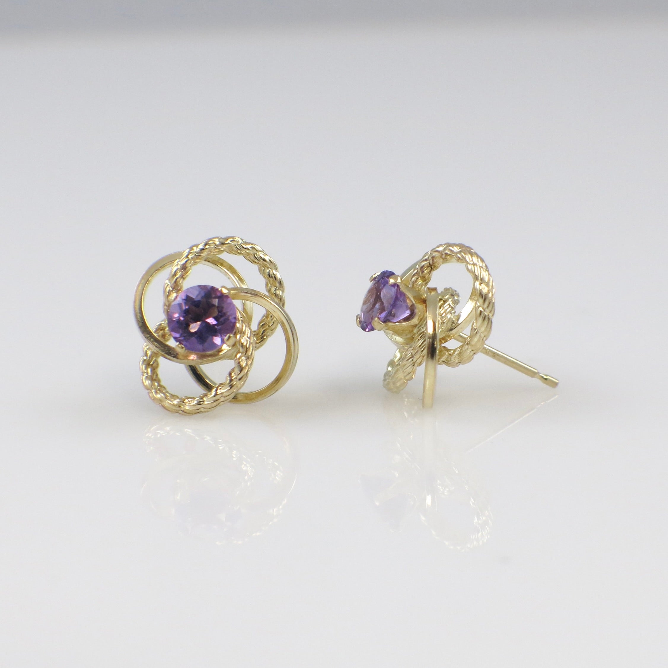 Vintage 14K yellow gold amethyst openwork stud earrings with intricate design and gemstone accents, crafted by Black Market LLC.