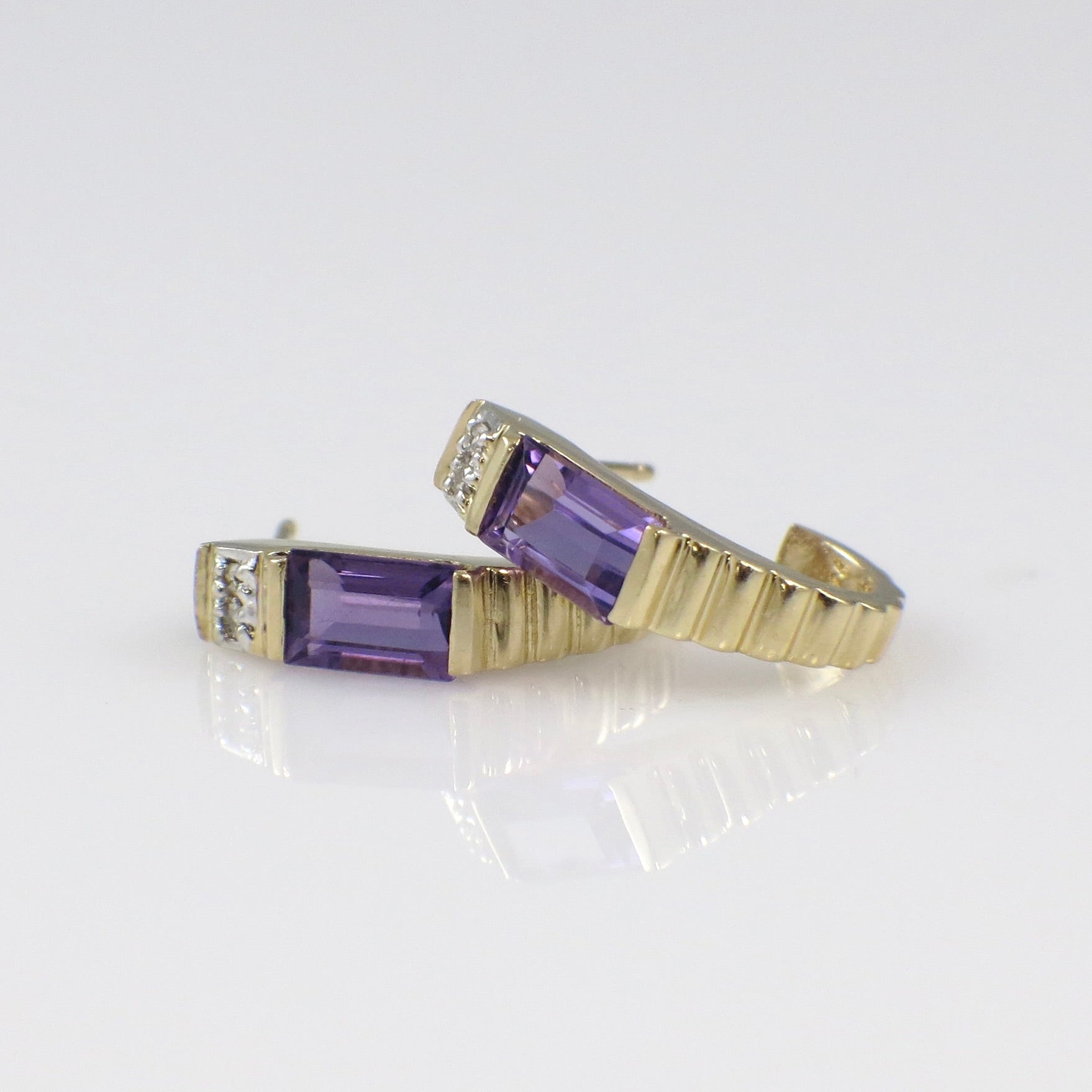 Vintage 14K yellow gold amethyst and diamond J hoop earrings with intricate design and sparkling gemstone accents.