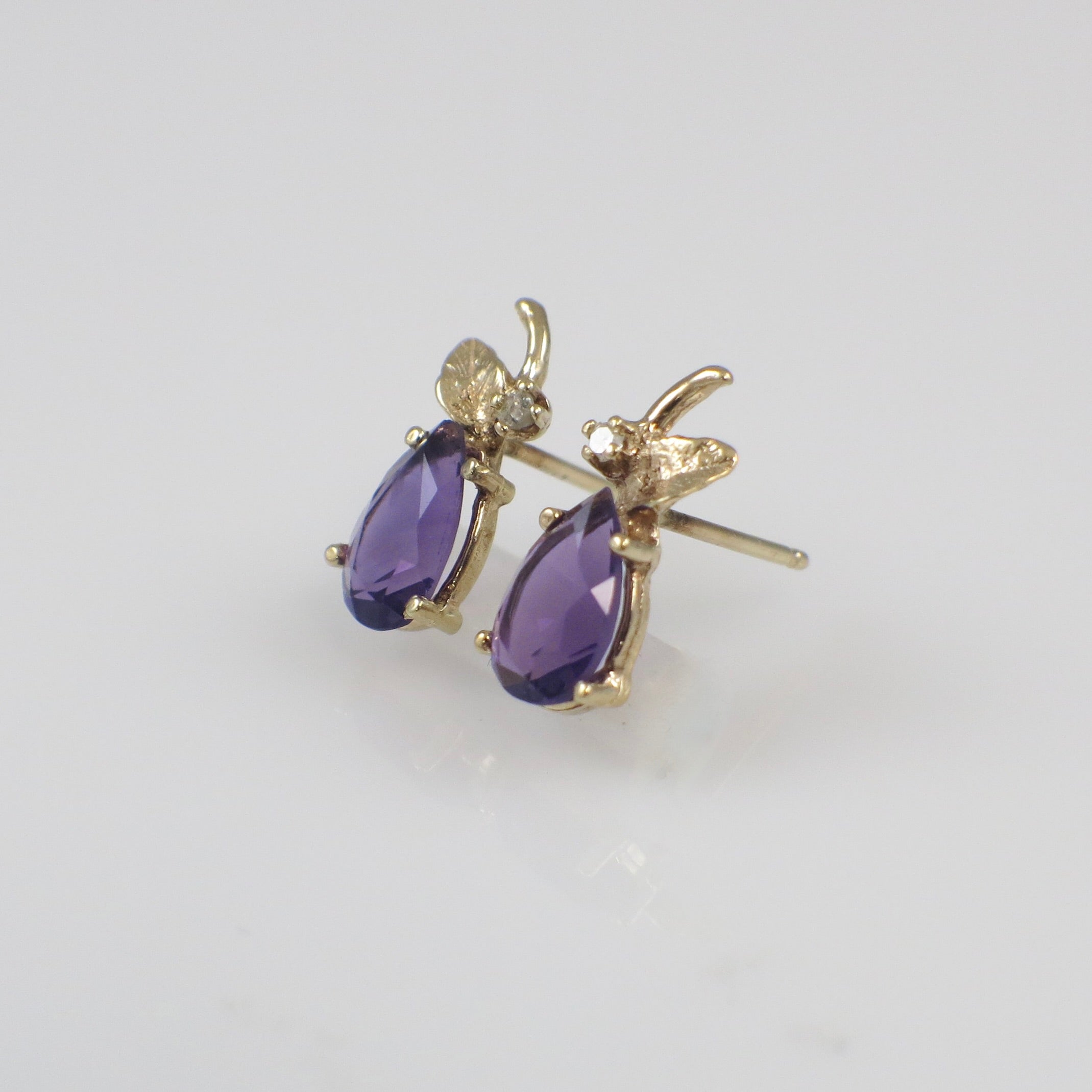 Vintage 14K gold amethyst and diamond stud earrings featuring elegant gemstone settings and classic jewelry design.