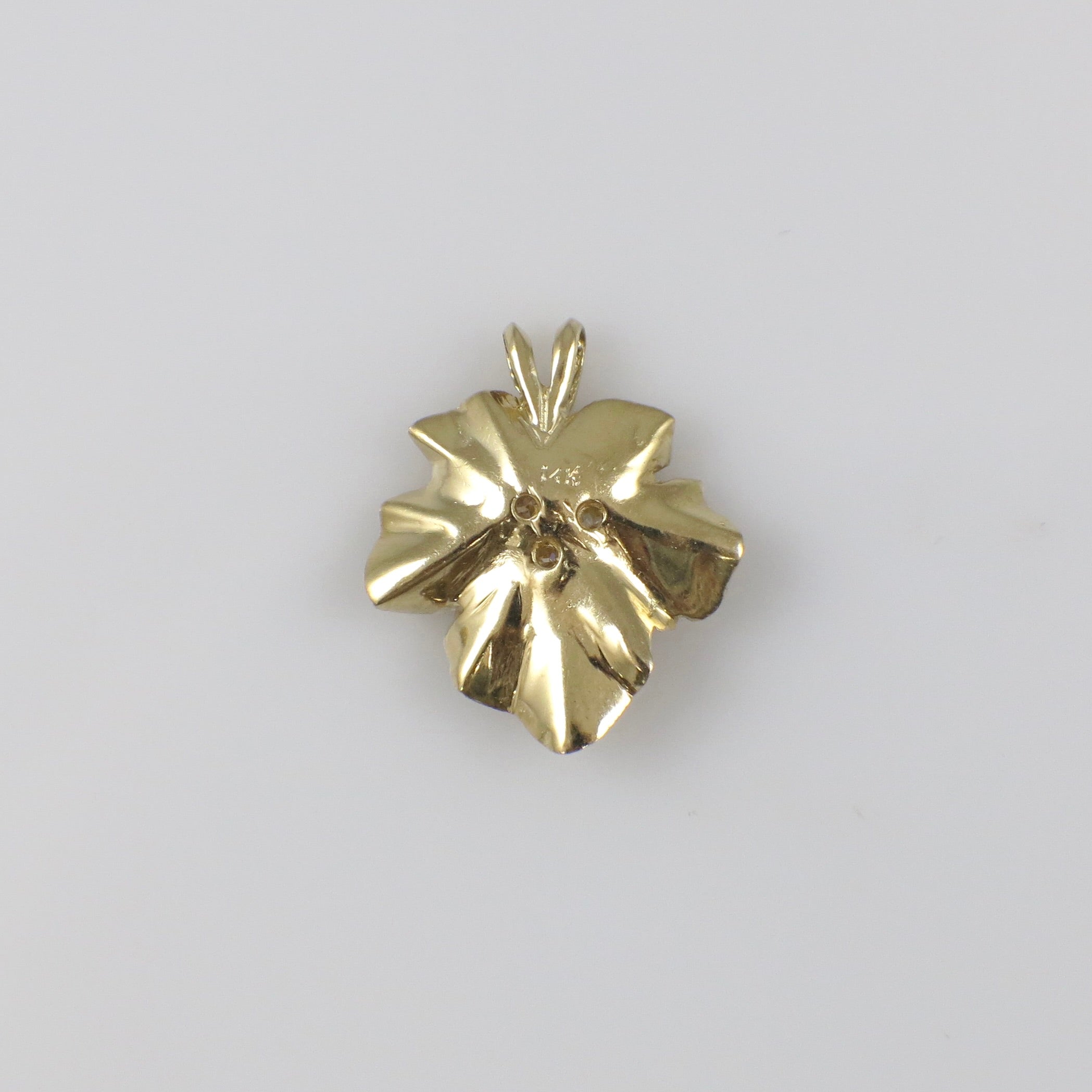 Vintage 14K yellow gold diamond floral pendant necklace with intricate design and sparkling diamonds.