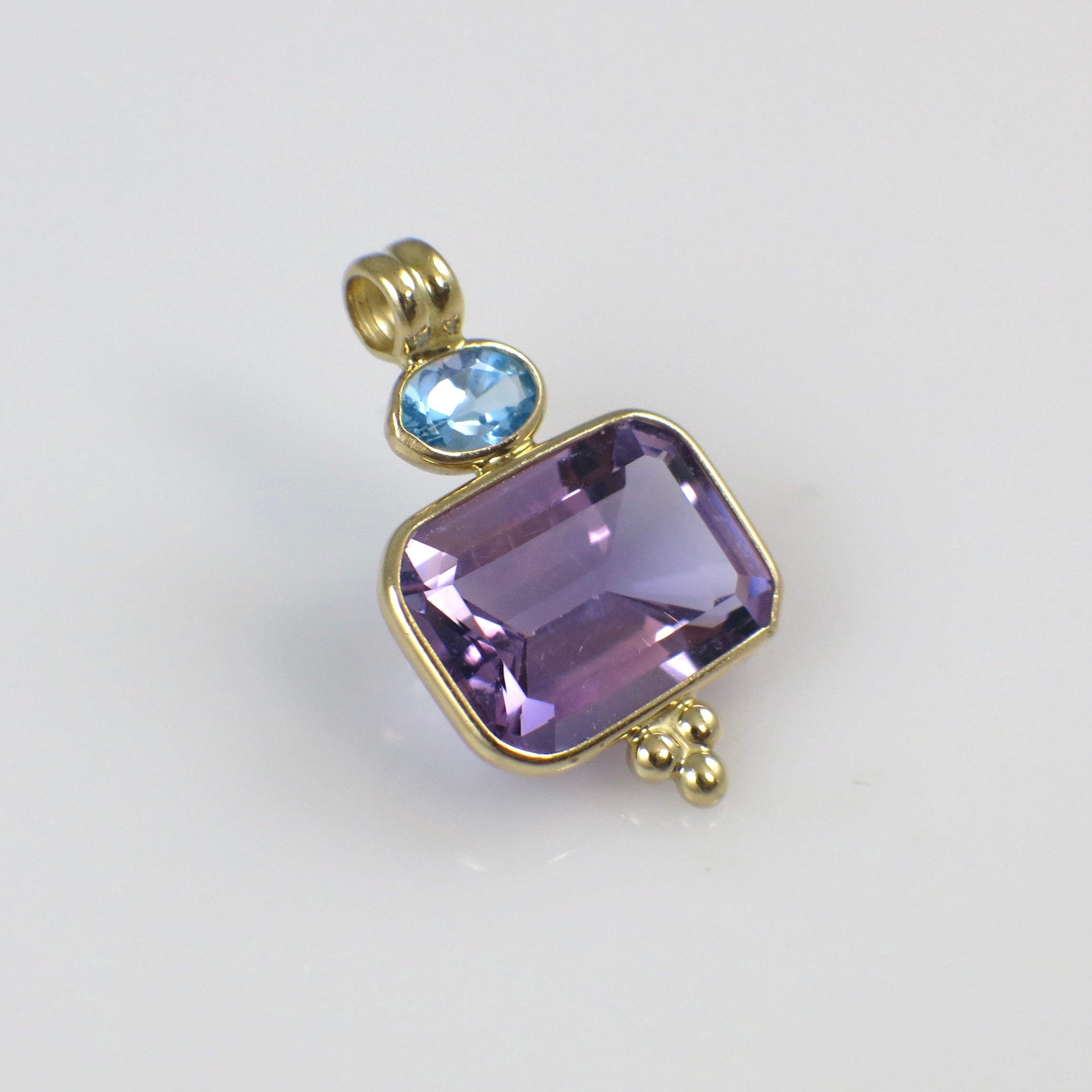 Vintage 14K yellow gold amethyst and Swiss blue topaz pendant necklace with intricate detailing and gemstone accents.
