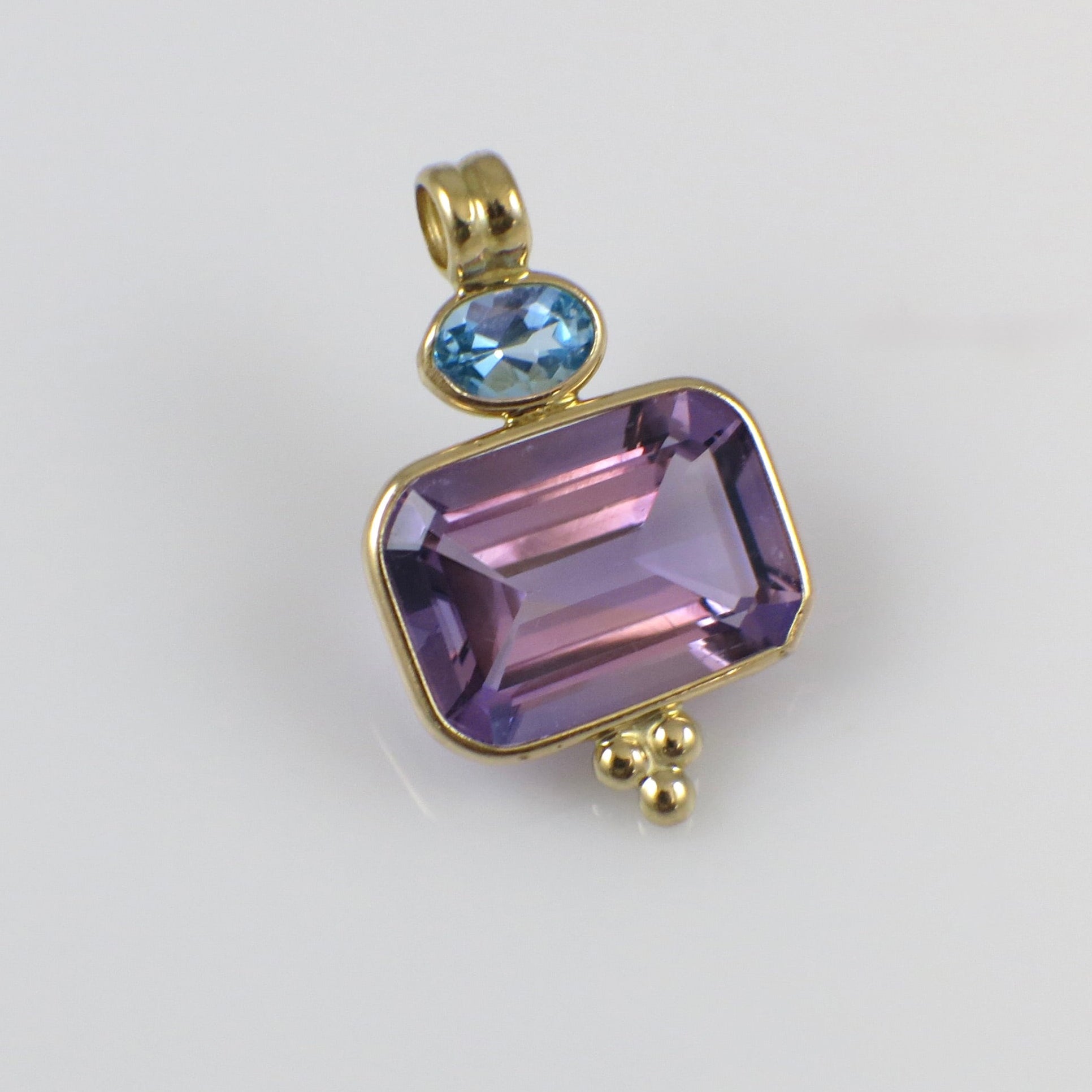 Vintage 14K yellow gold amethyst and Swiss blue topaz pendant necklace with intricate design, crafted by Black Market LLC.
