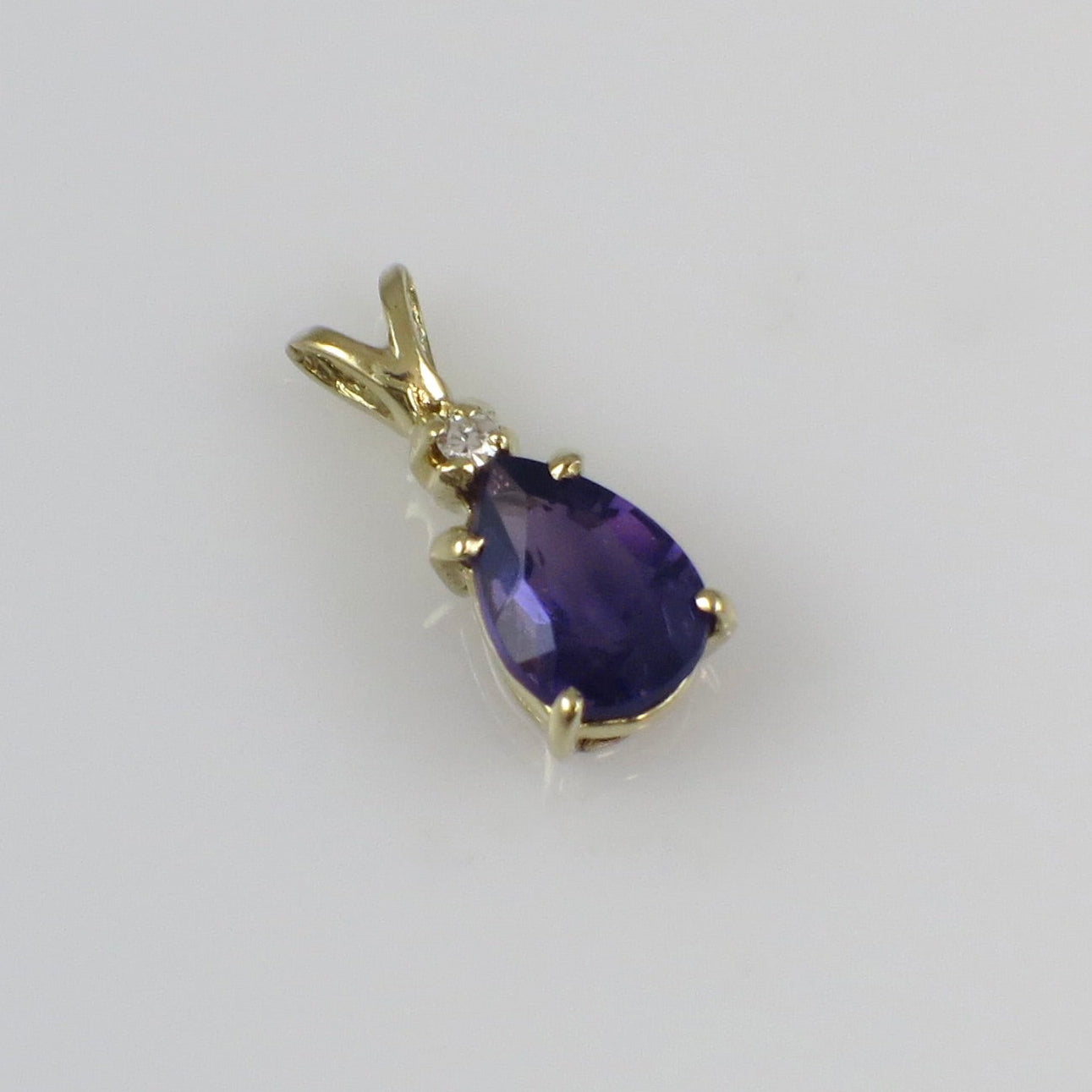 Vintage 14K yellow gold amethyst and diamond pendant necklace with intricate design and gemstone details.