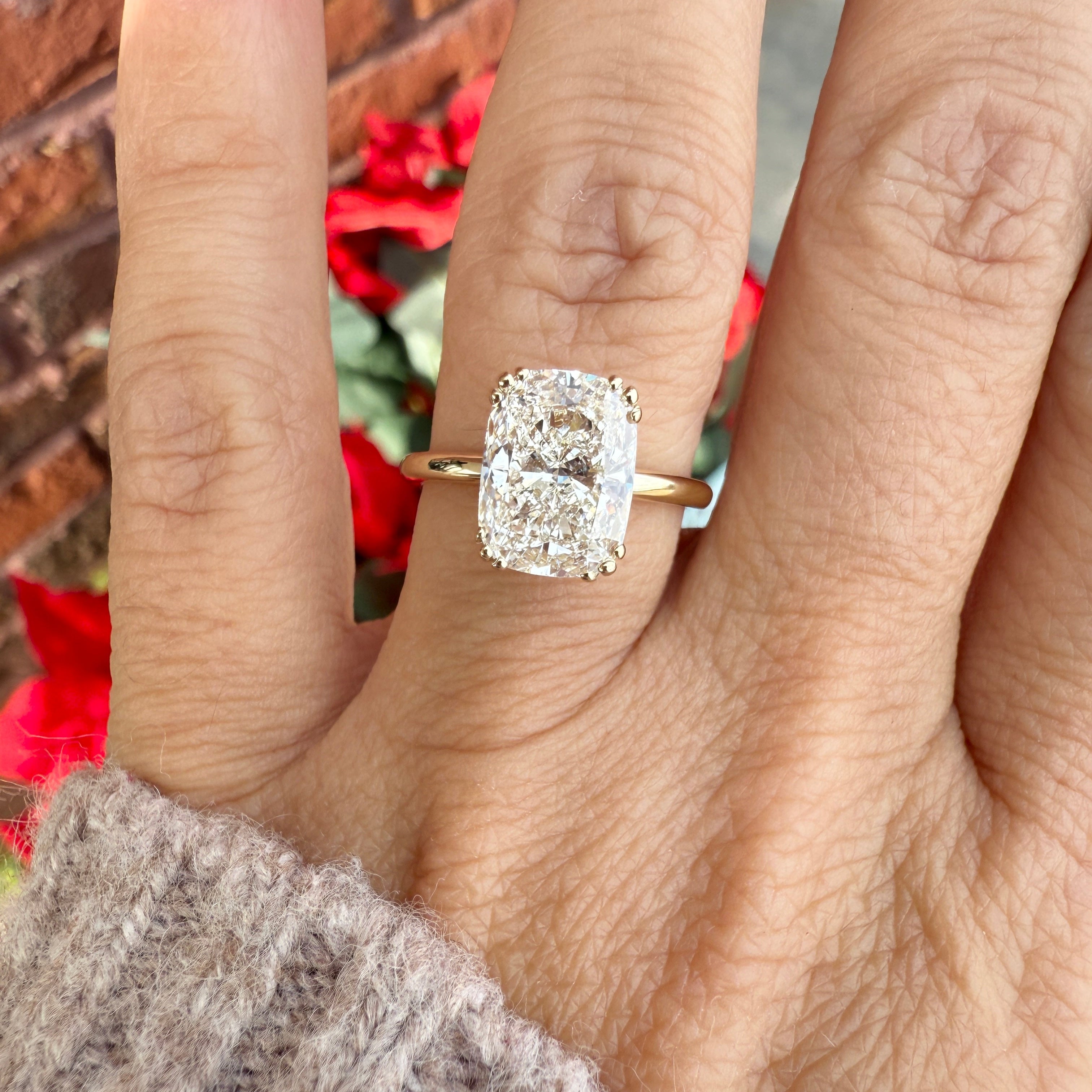 Diamond ring on a finger with a blurred background