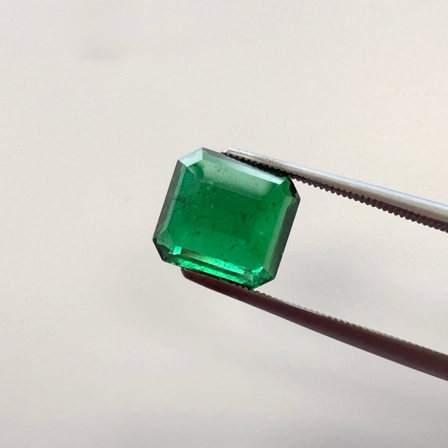 GIA certified 2.43ct emerald gemstone with octagonal step cut, minor enhancement, measuring 8.44 x 7.85mm, from Black Market LLC