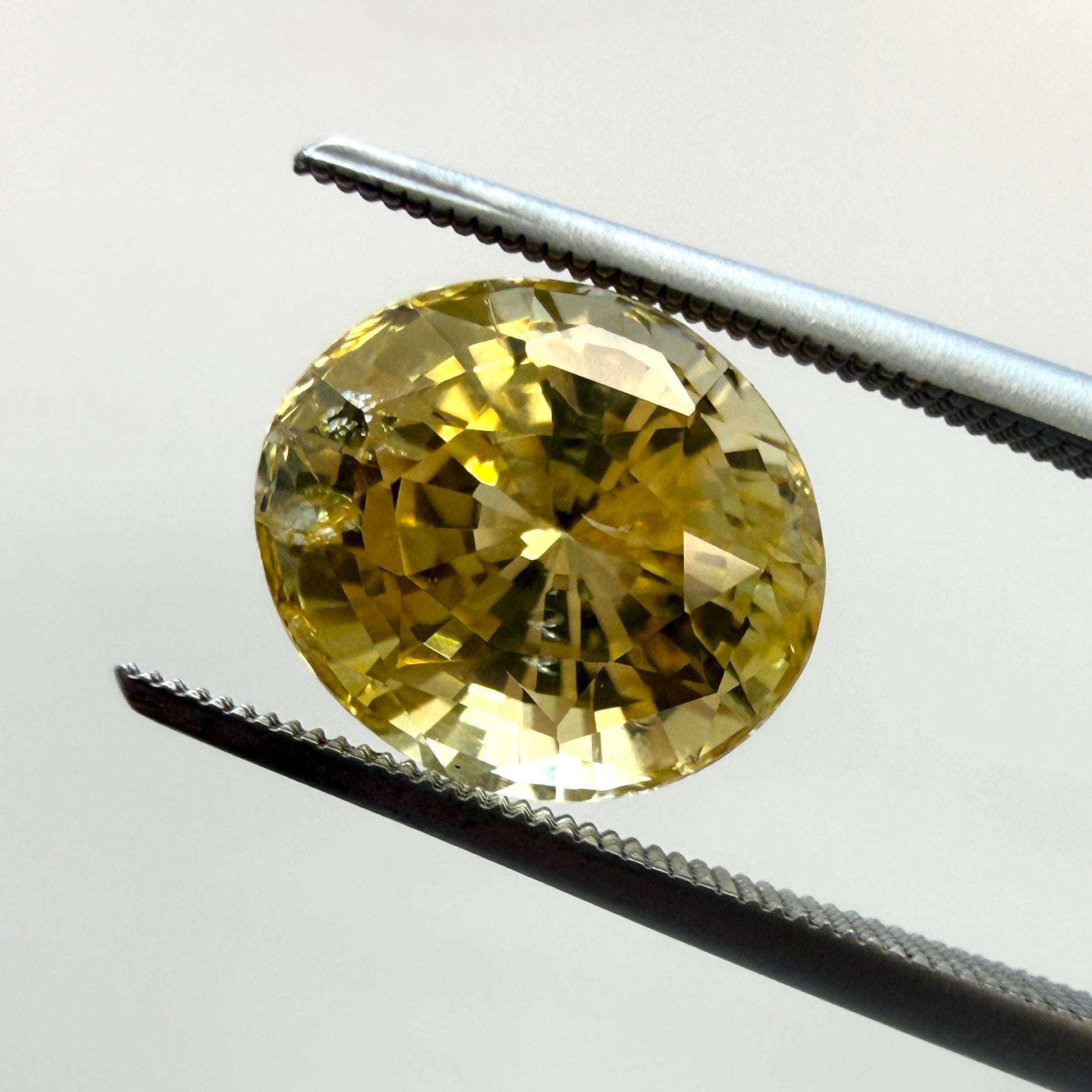 Oval GIA yellow sapphire gemstone, 4.10ct, heated natural yellow sapphire from Black Market LLC, shown with dimensions 9.77x8.56mm.