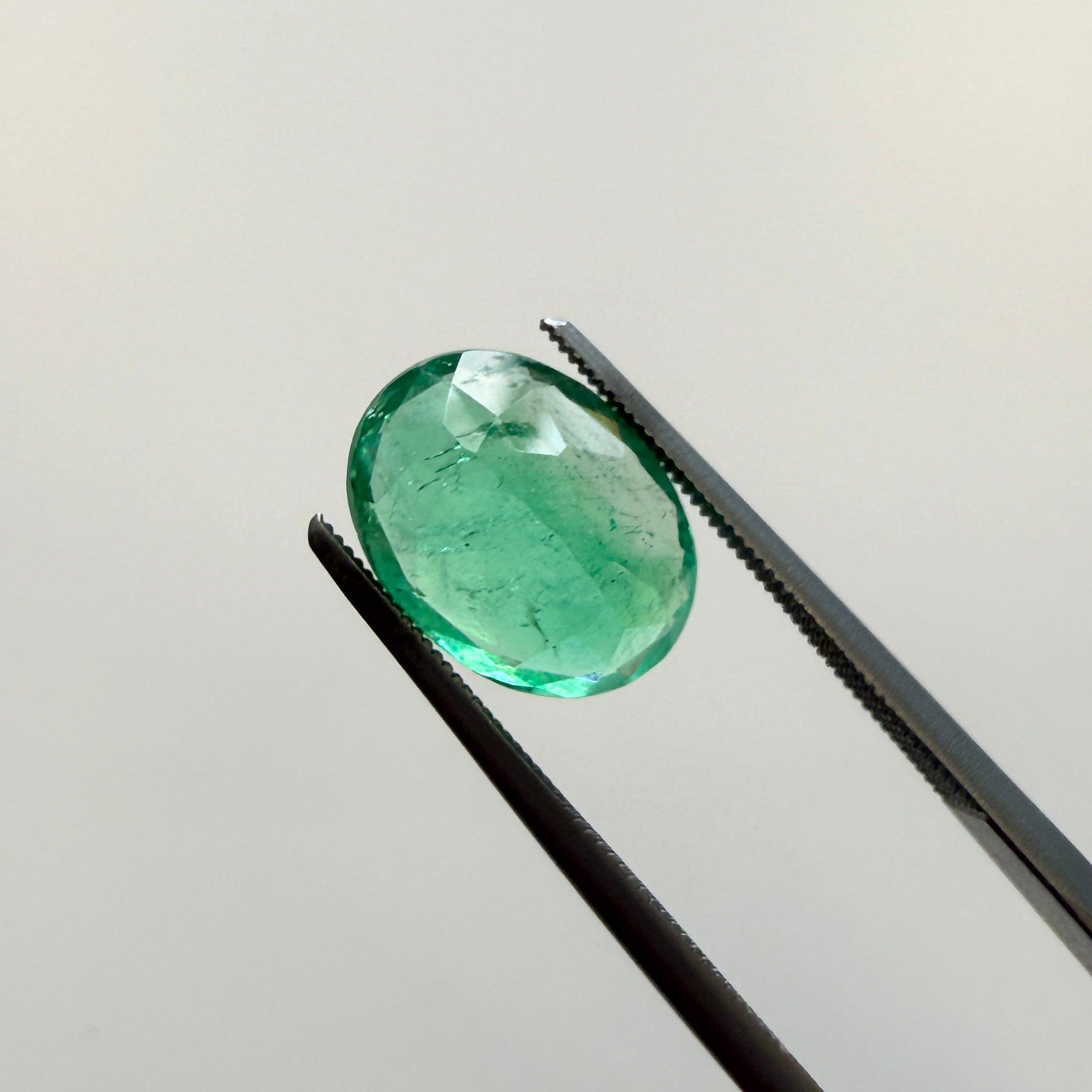 GIA Certified 2.45ct oval green beryl gemstone with minor enhancement, measuring 10.54 x 7.94mm, by Black Market LLC