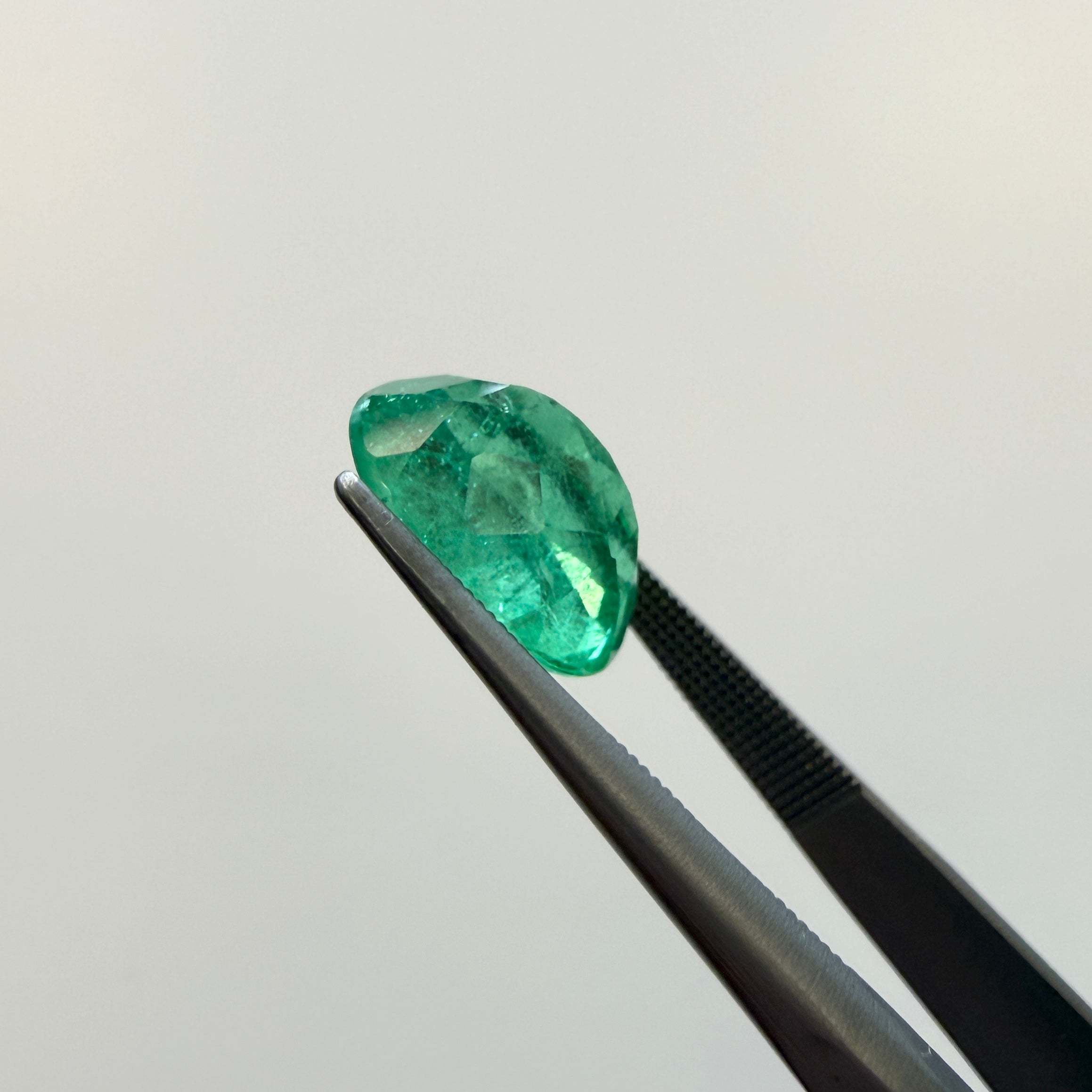 GIA Certified 2.45ct oval green beryl gemstone with minor enhancement, measuring 10.54 x 7.94mm, from Black Market LLC