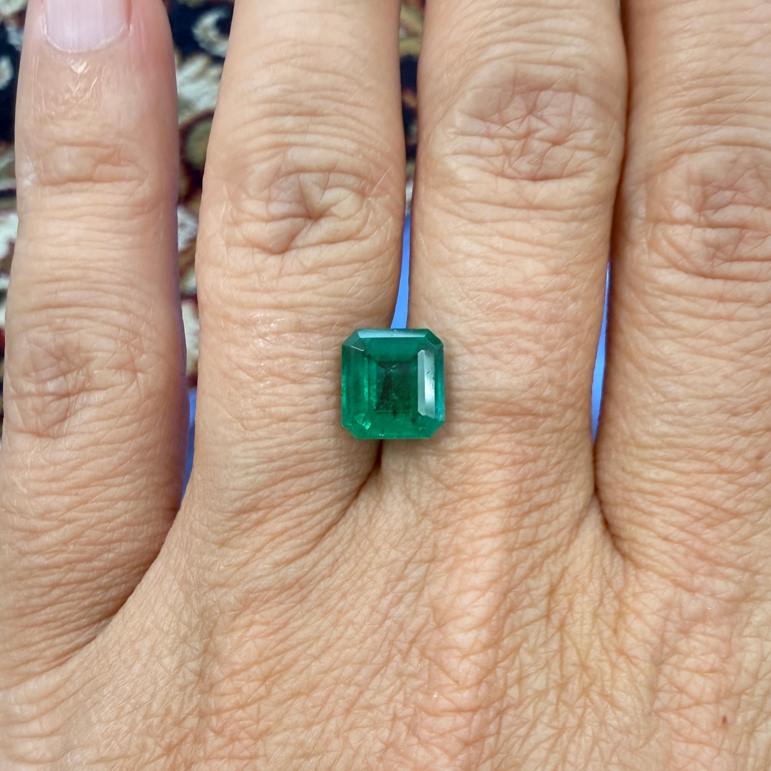 GIA Certified emerald gemstone, 2.43ct octagonal step cut, minor enhancement, measuring 8.44 x 7.85mm, black Market LLC.