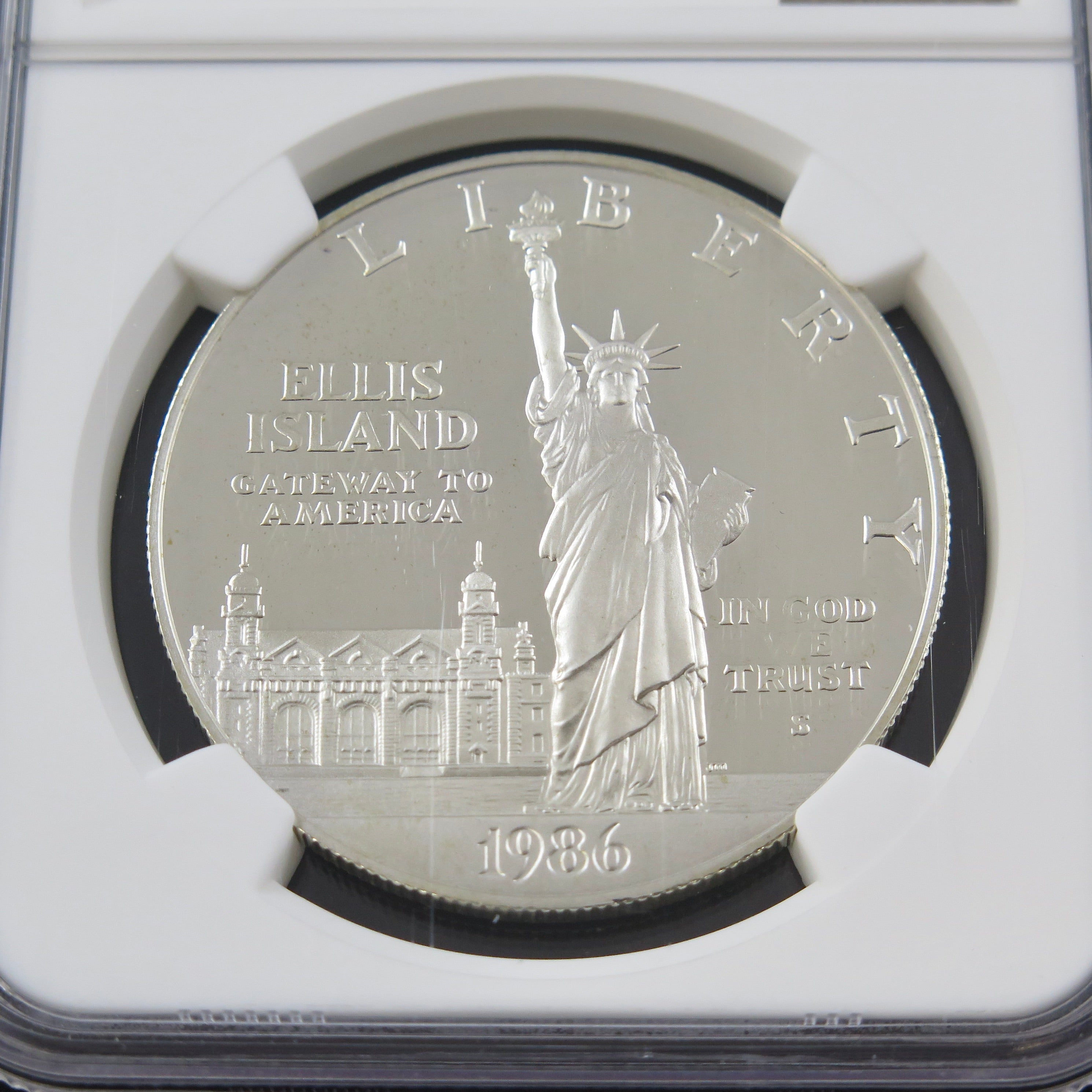 Close-up of the Liberty Silver Dollar 1986-S commemorative coin in ultra cameo finish, showcasing detailed design and NGC PF69 certification.