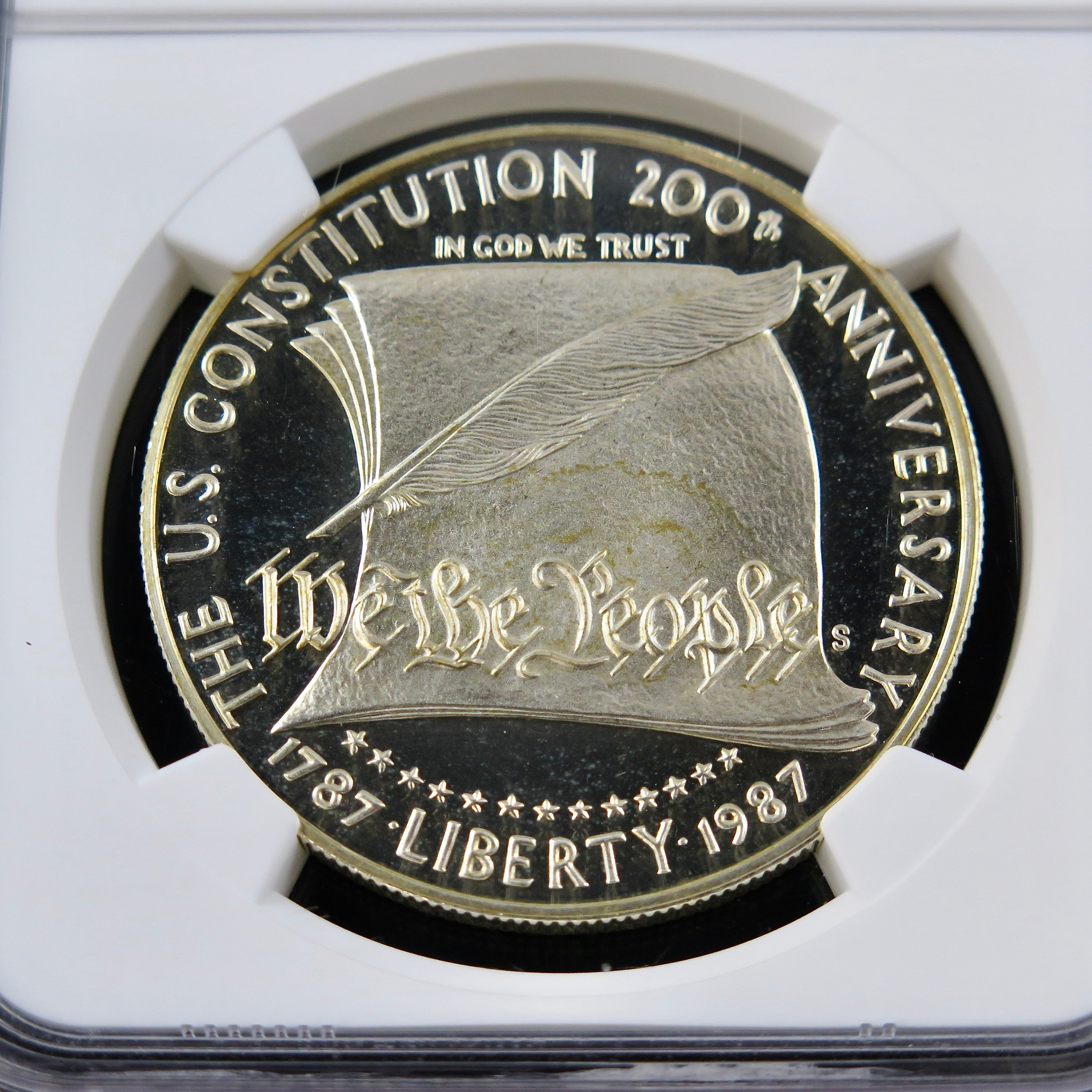 1987-S Constitution Silver Dollar commemorative coin with PF69 Ultra Cameo grade, showcasing detailed design and reflective surface.