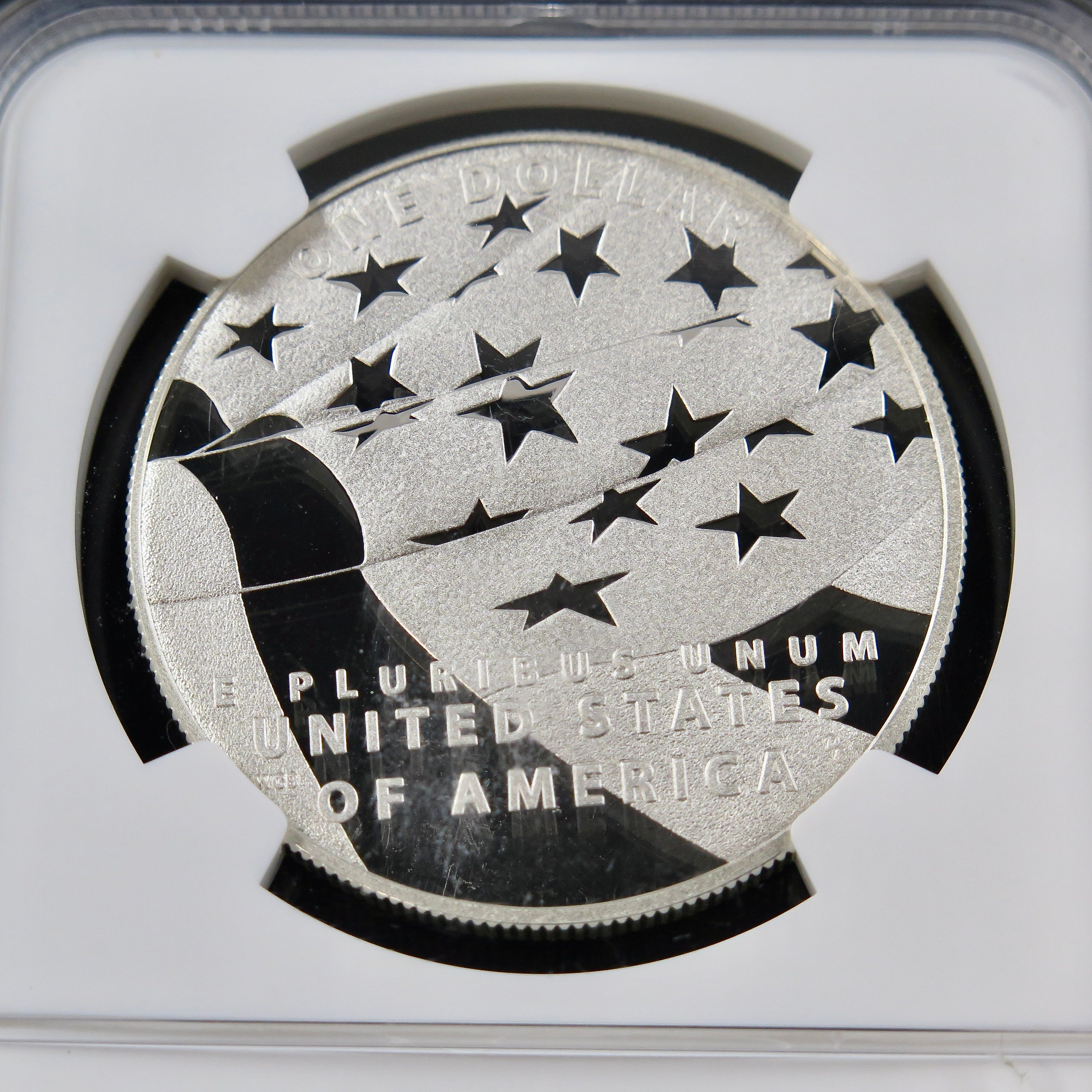 Close-up of a 2012-P Star Spangled Banner Dollar commemorative coin in PF70 grade, showcasing intricate design details and patriotic imagery.