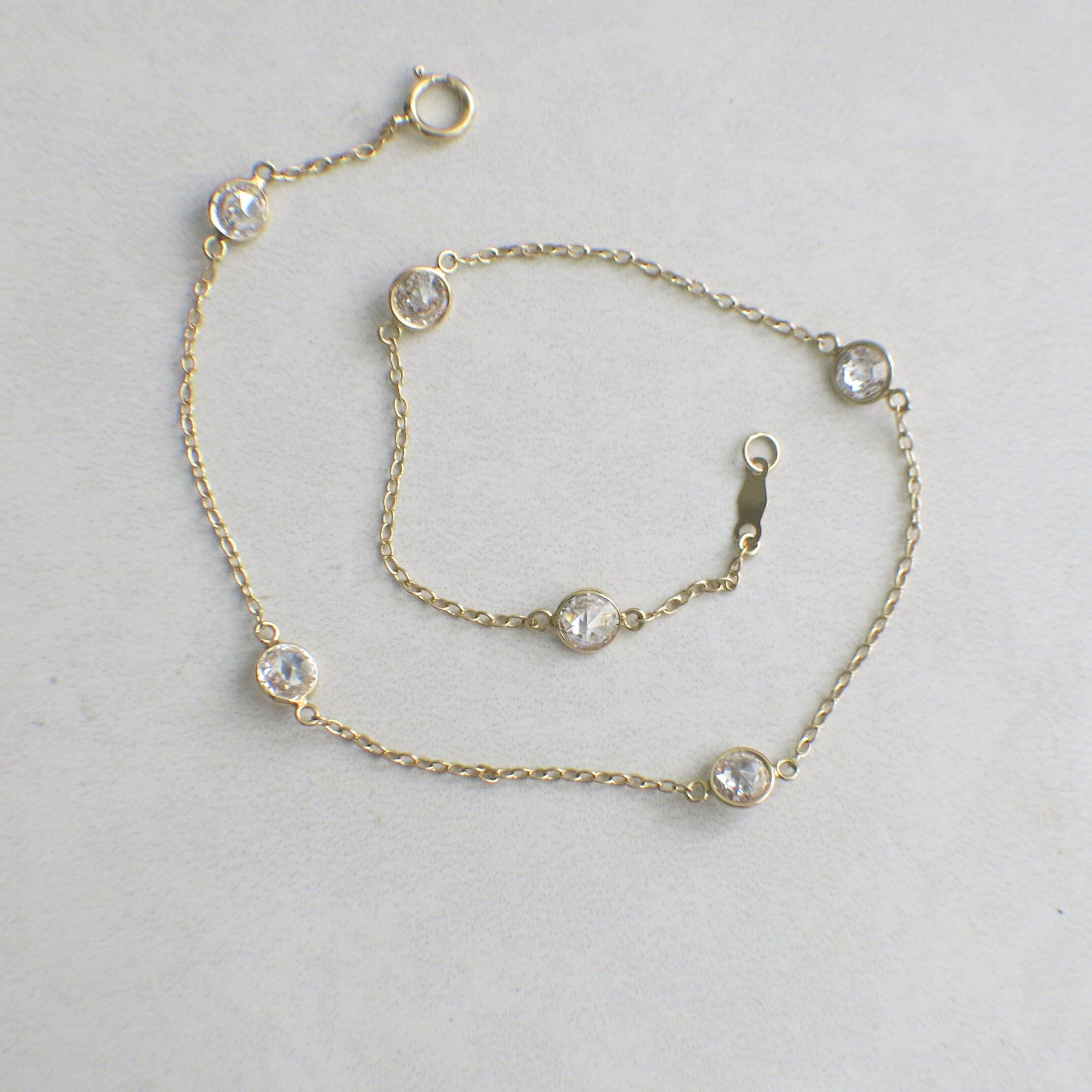 14K yellow gold CZ station bracelet by Black Market LLC, 10-inch extra long bezel set design with sparkling cubic zirconia stones.