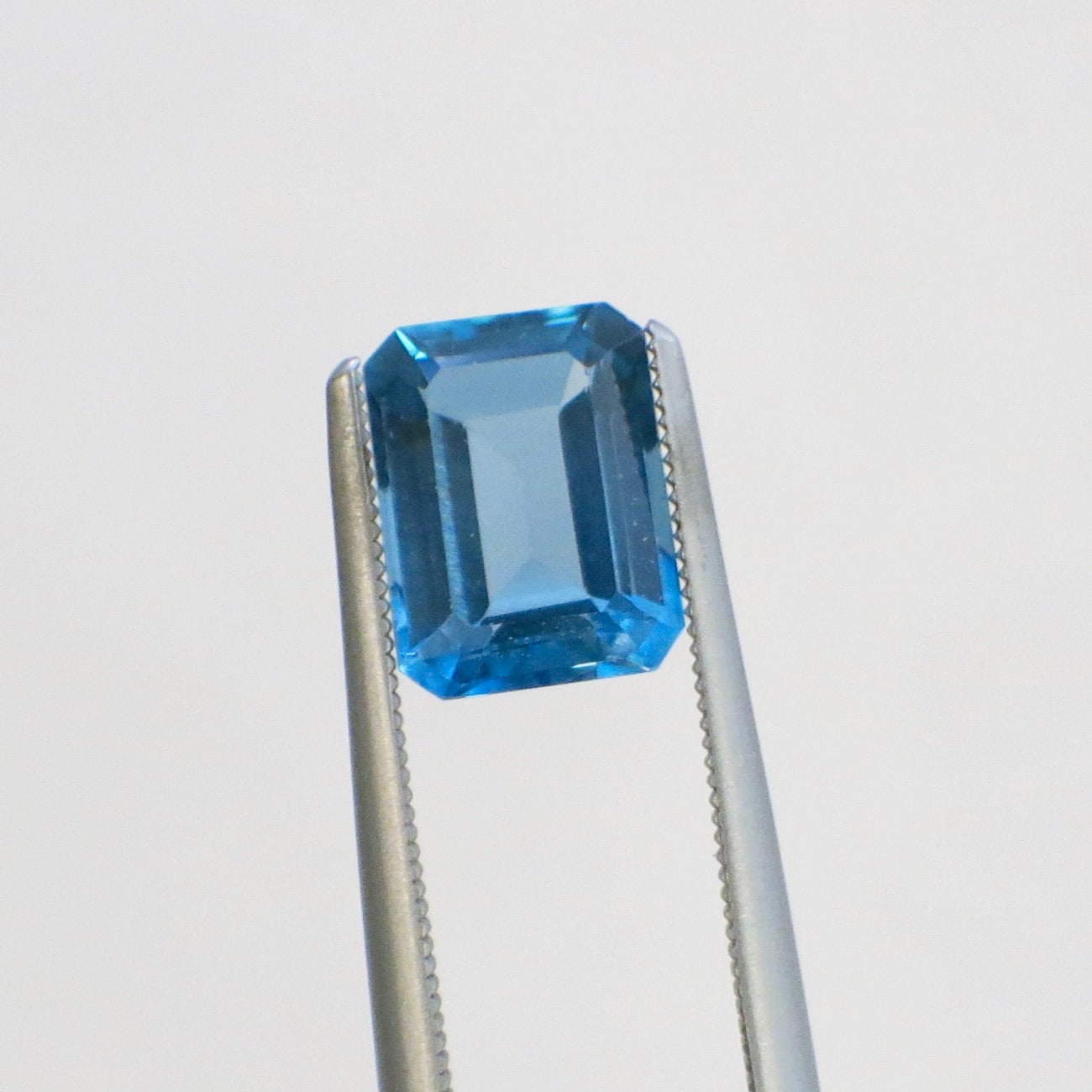 2.08 carat emerald cut blue topaz loose gemstone, 8x6mm December birthstone, from Black Market LLC.