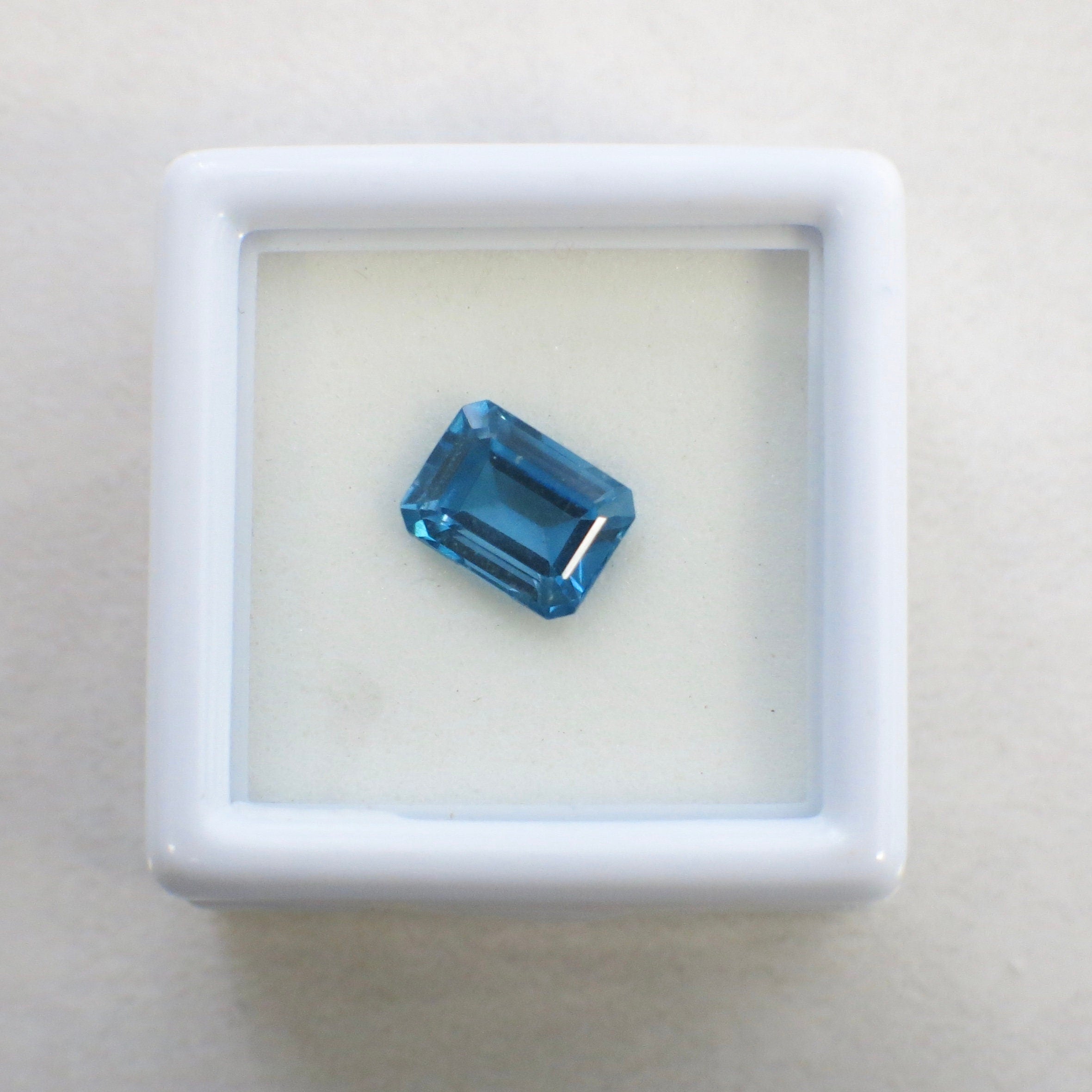 2.08 Carat emerald cut blue topaz loose gemstone, 8x6mm, December birthstone, from Black Market LLC.